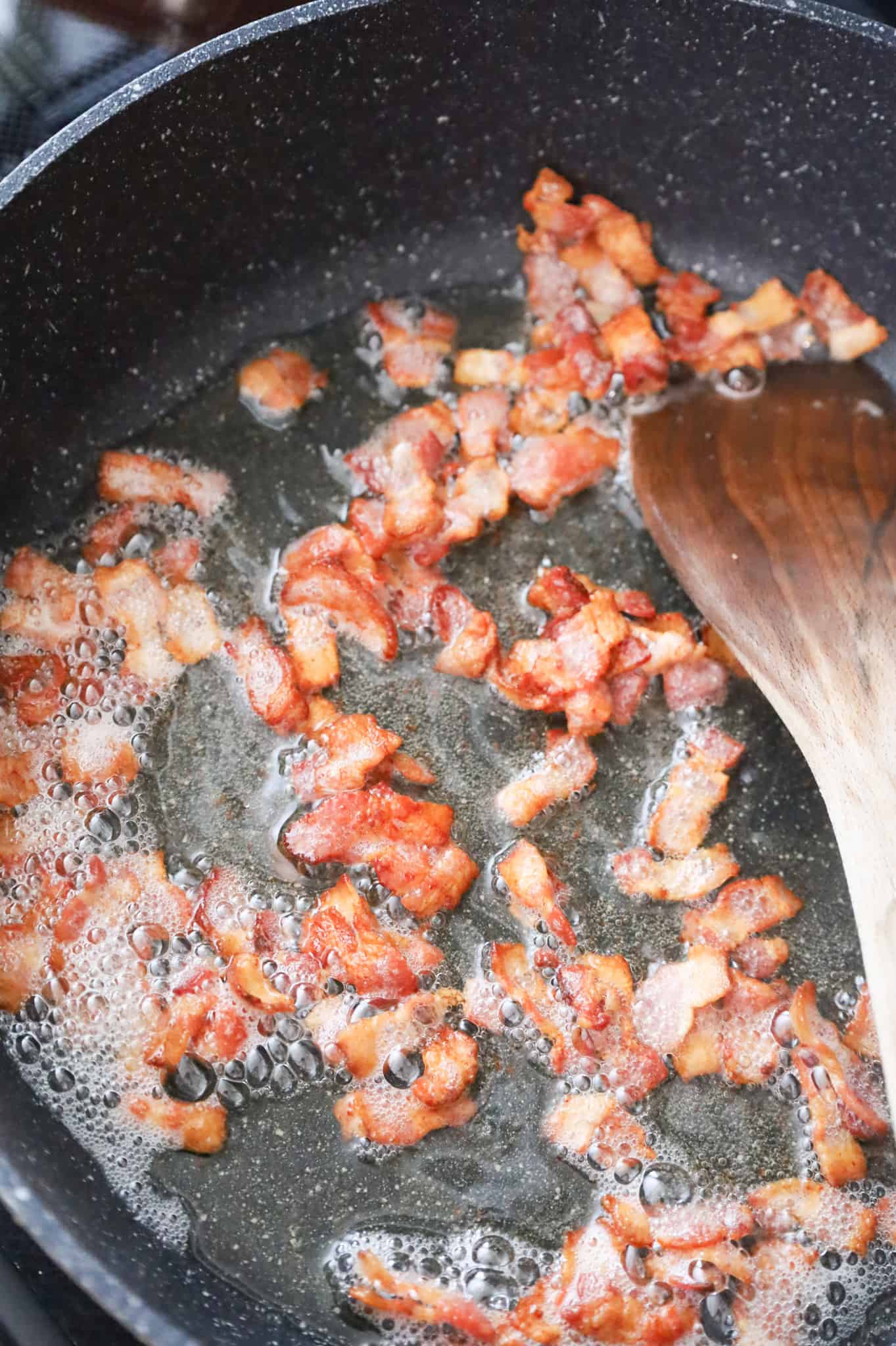 cooked bacon pieces in a skillet