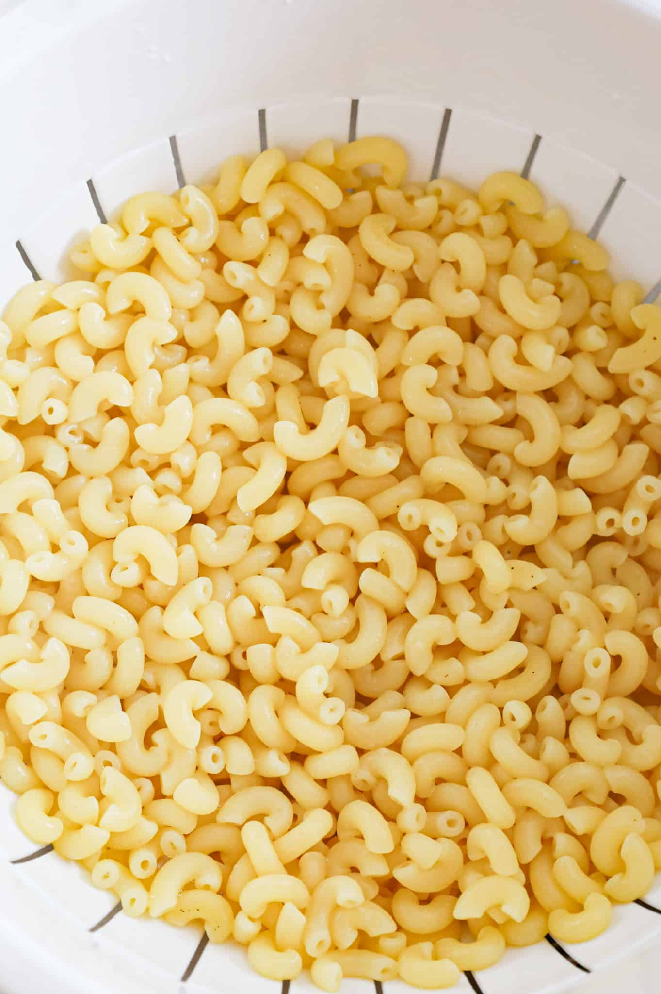 cooked macaroni noodles in a colander