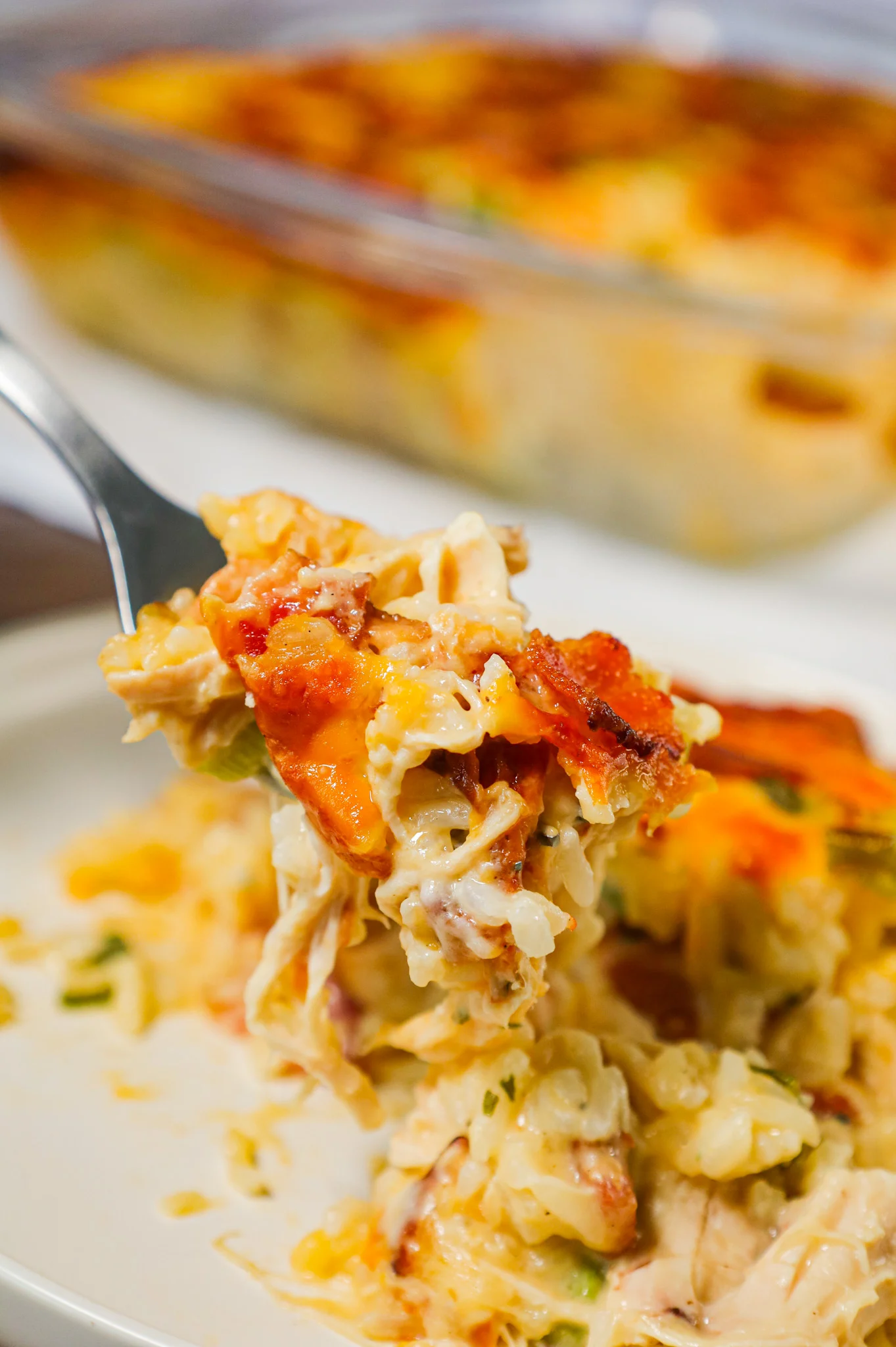 Chicken Bacon Ranch Casserole is a hearty chicken and rice casserole loaded with cream of chicken soup, cream of bacon soup, cheddar soup, ranch dressing mix, chopped bacon and shredded cheese.