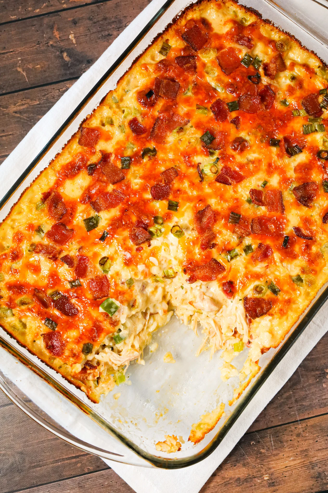 Chicken Bacon Ranch Casserole is a hearty chicken and rice casserole loaded with cream of chicken soup, cream of bacon soup, cheddar soup, ranch dressing mix, chopped bacon and shredded cheese.