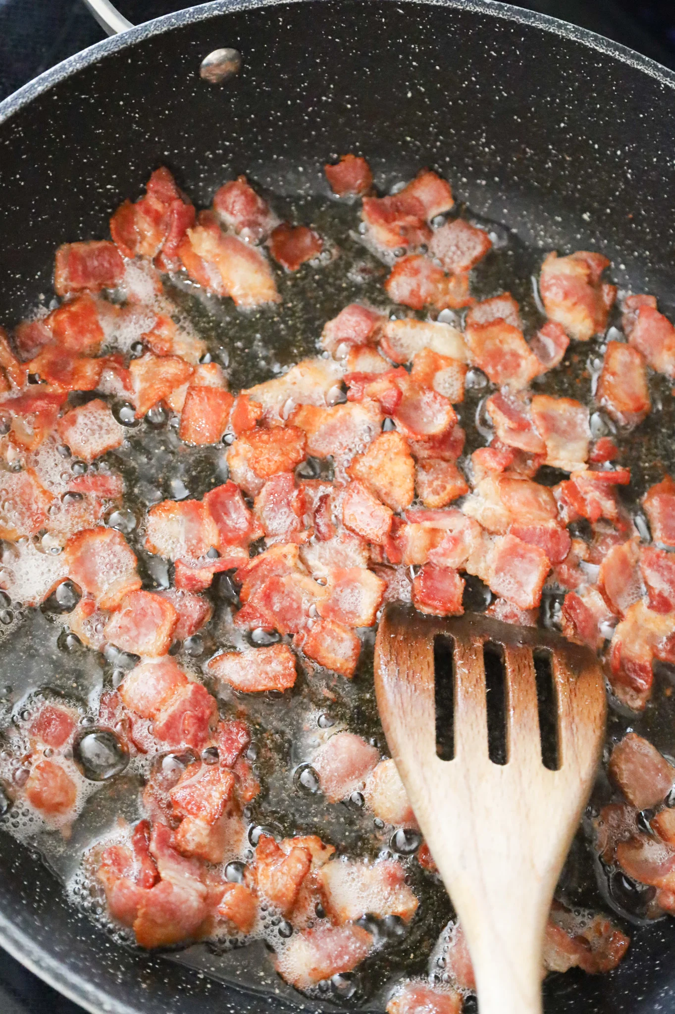 cooked bacon pieces in skillet