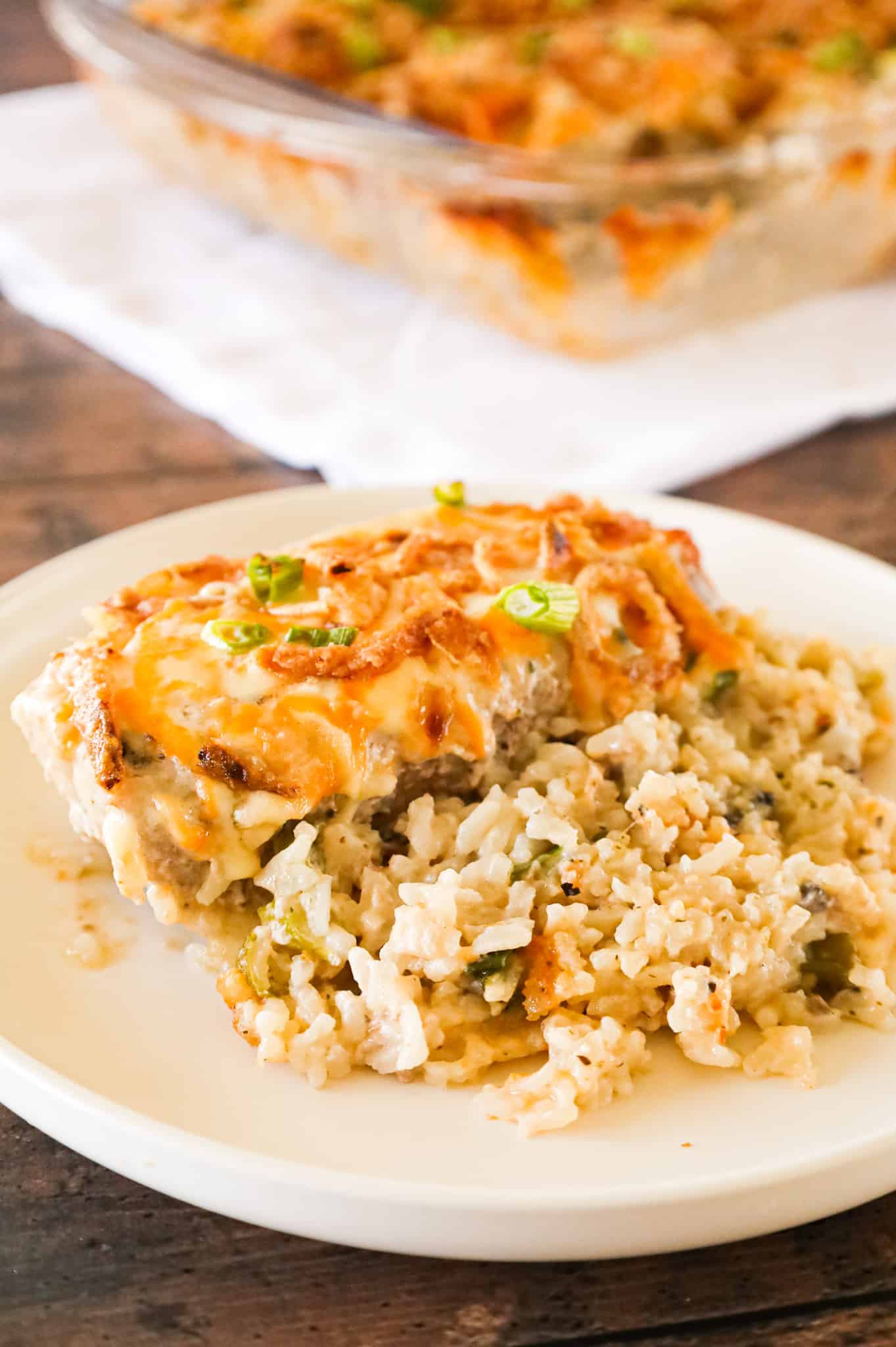 Pork Chop Casserole is a hearty one dish meal with a base of creamy instant rice topped with boneless pork chops, shredded cheese and crispy fried onions.