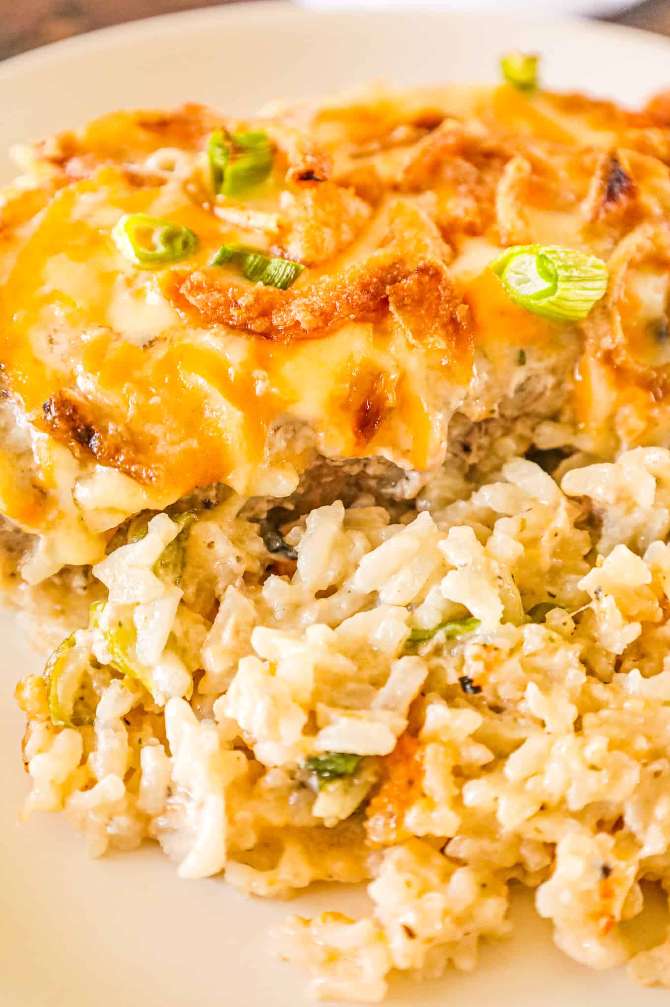 Pork Chop Casserole is a hearty one dish meal with a base of creamy instant rice topped with boneless pork chops, shredded cheese and crispy fried onions.