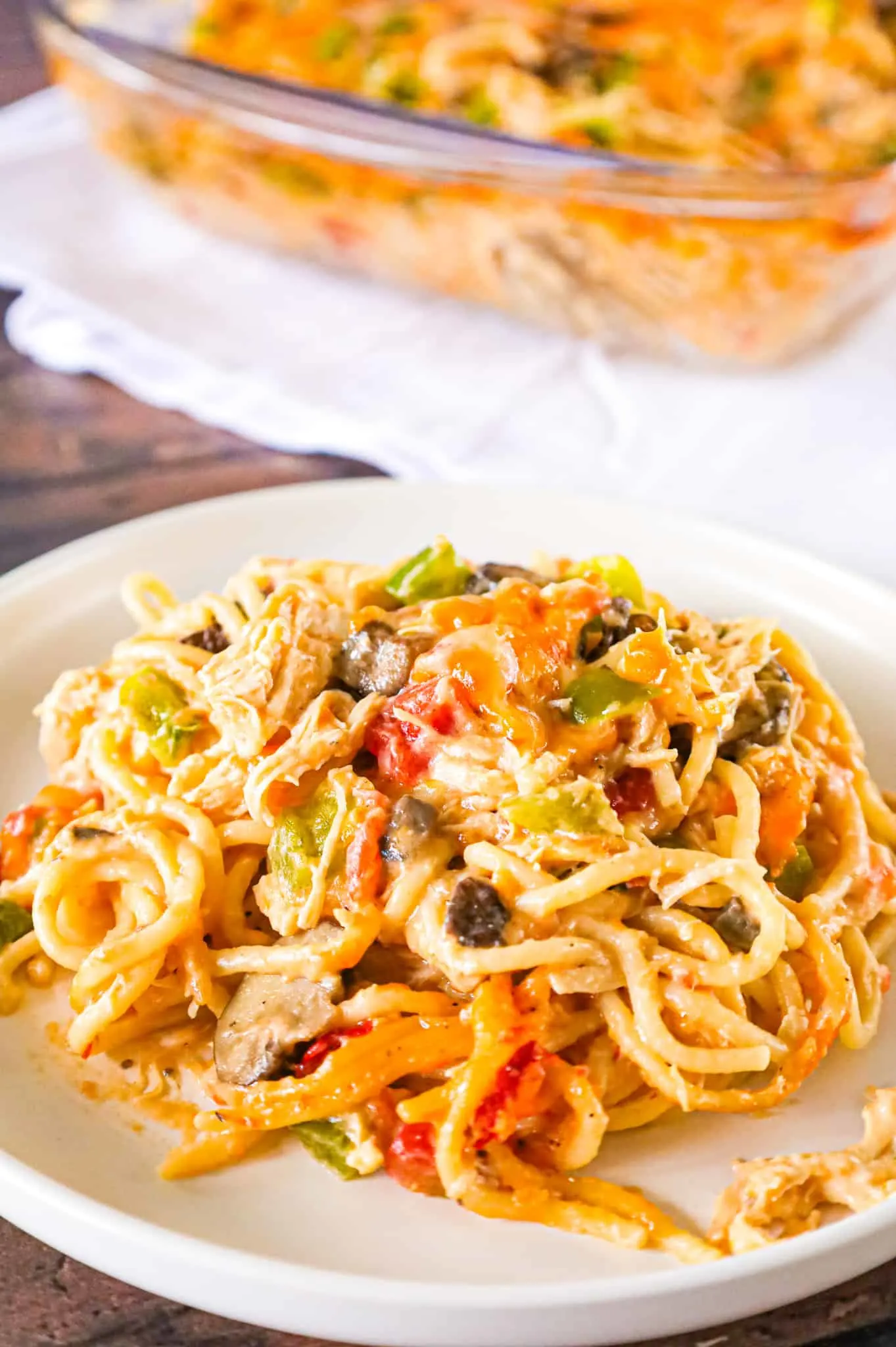 Texas Chicken Spaghetti is a hearty baked pasta recipe loaded with shredded chicken, cream of mushroom soup, cream of chicken soup, Rotel diced tomatoes and green chilies, diced green peppers, sliced mushrooms and shredded cheese.