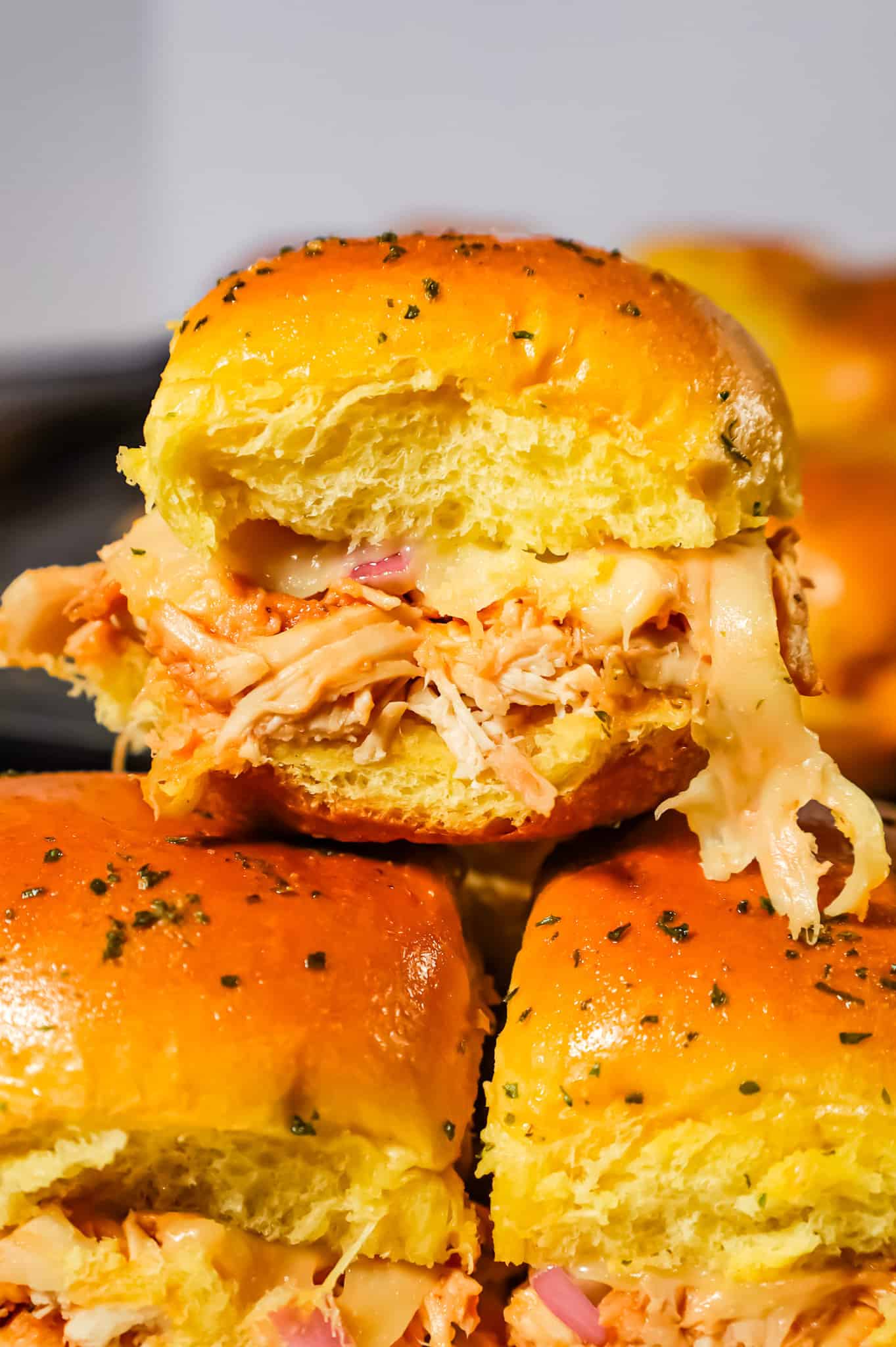 BBQ Chicken Sliders are an easy weeknight dinner recipe using rotisserie chicken tossed in BBQ sauce and baked on dinner rolls with Monterey Jack cheese.