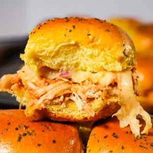 BBQ Chicken Sliders are an easy weeknight dinner recipe using rotisserie chicken tossed in BBQ sauce and baked on dinner rolls with Monterey Jack cheese.