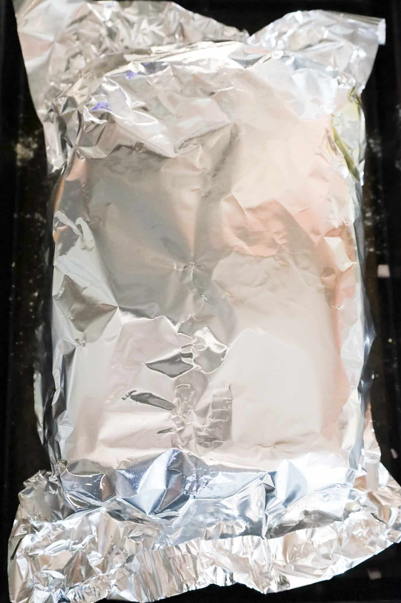 aluminum foil covering sliders on a baking sheet