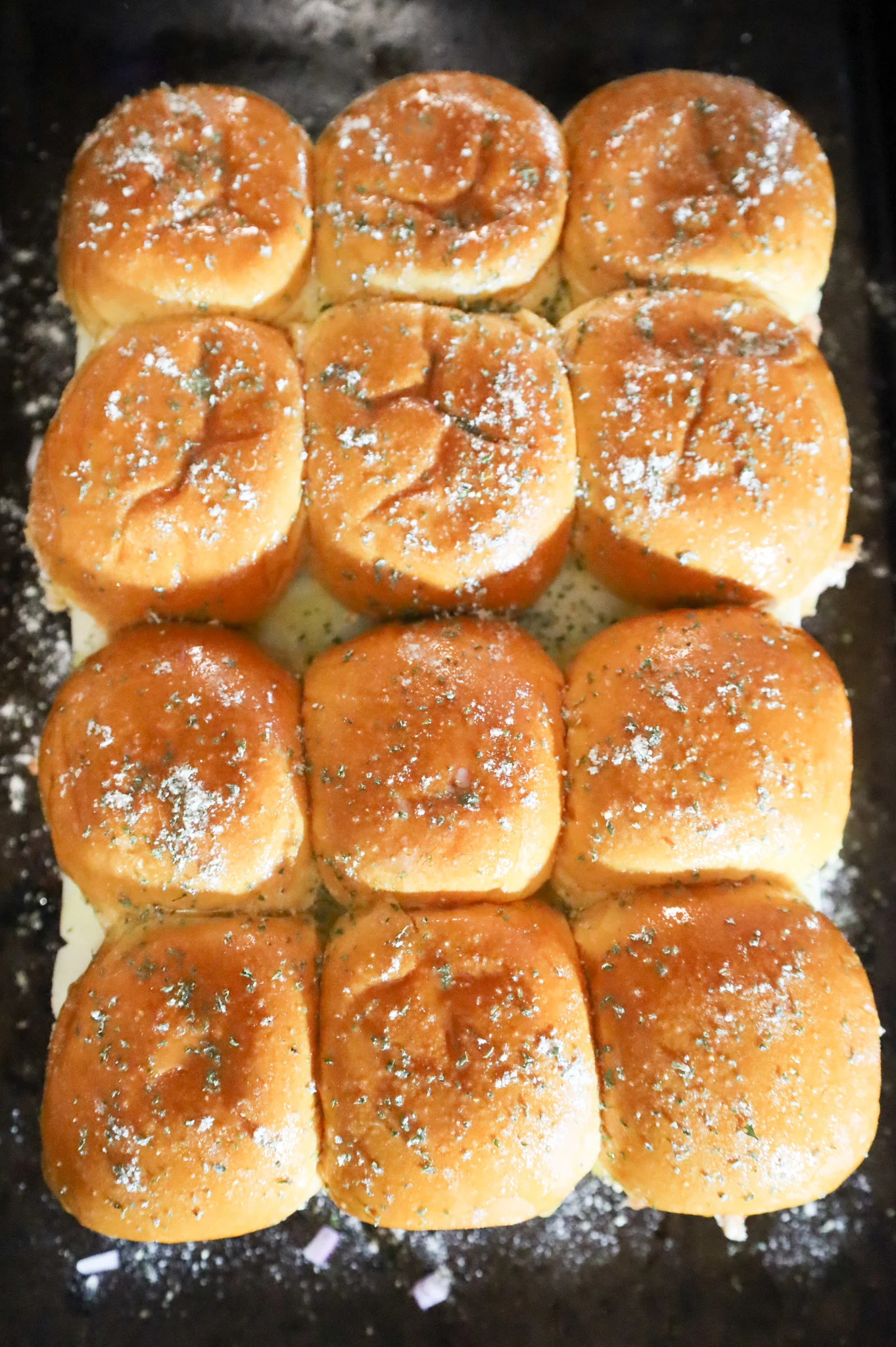 seasoning sprinkled on top of slider buns