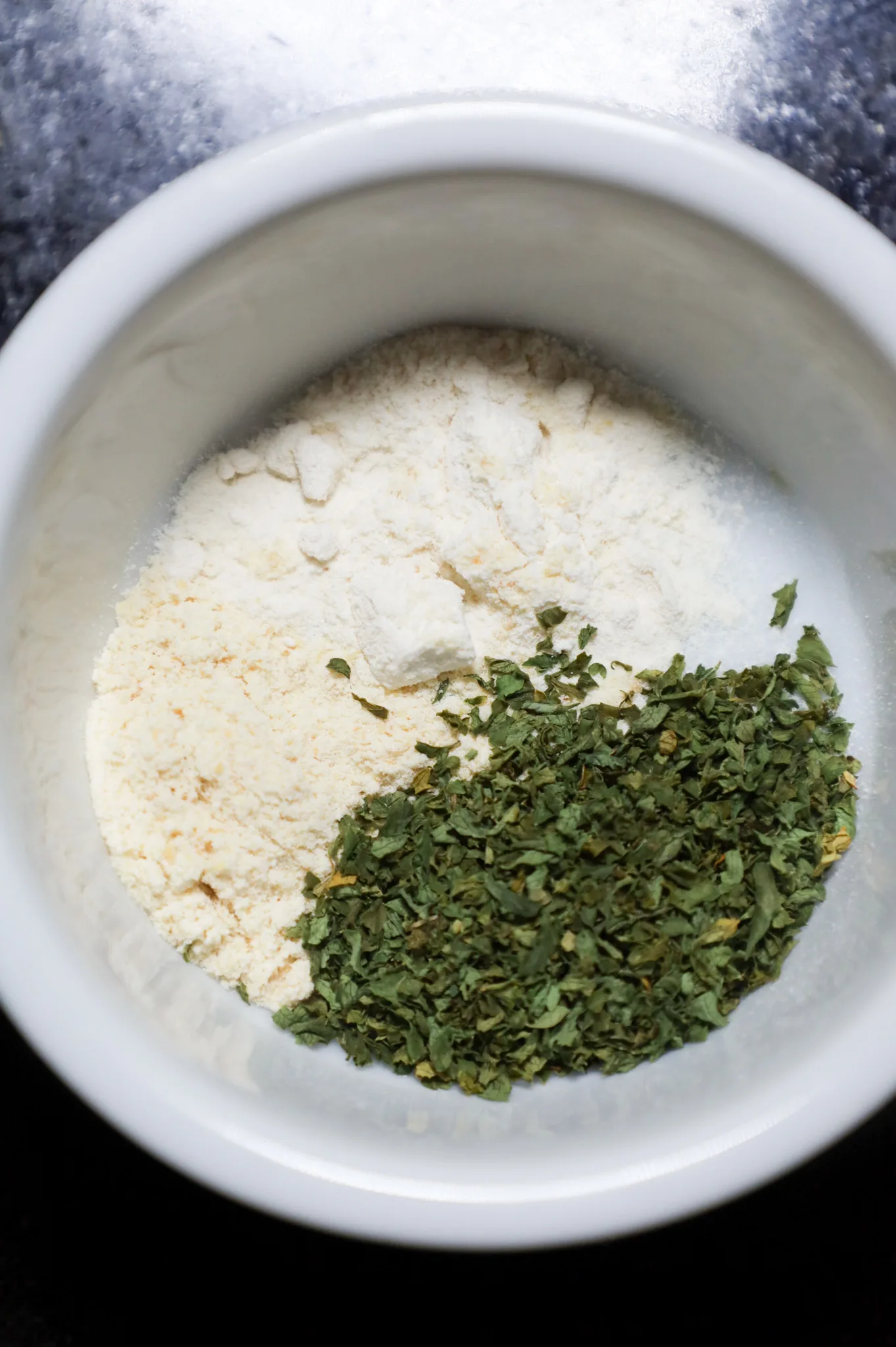 onion powder, garlic powder and parley flakes in a small bowl