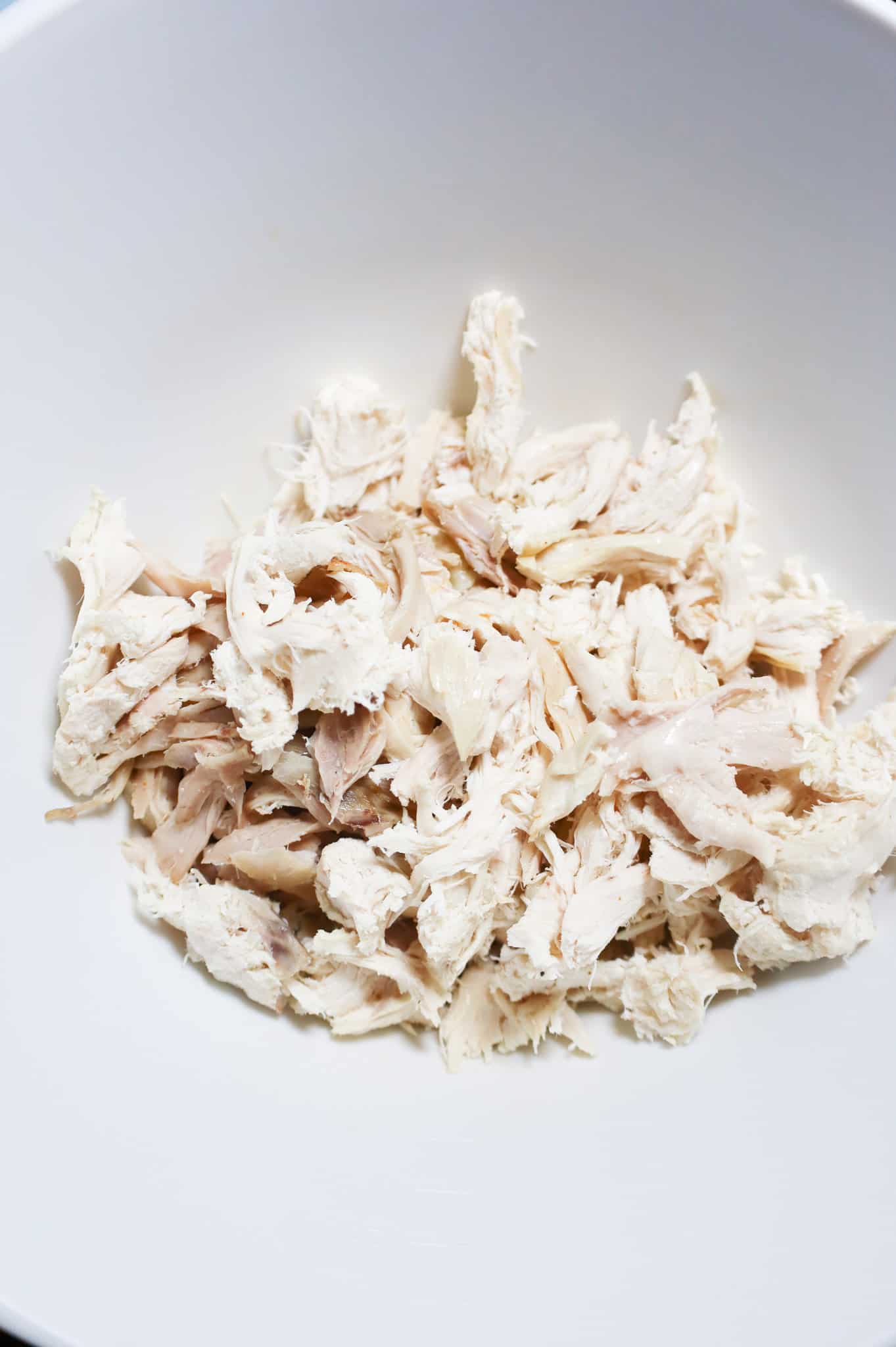 shredded chicken in a mixing bowl