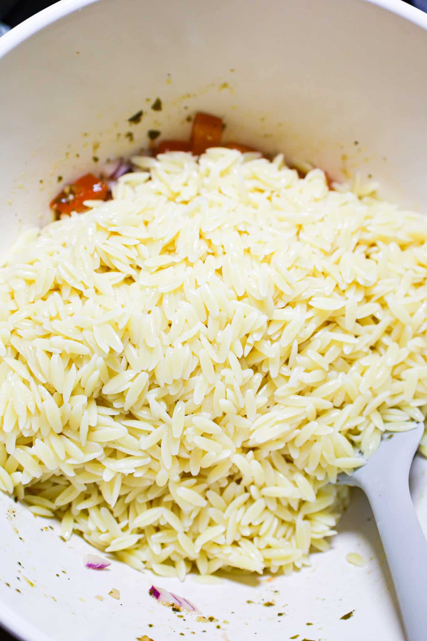 cooked orzo noodles added to bowl with tomato bruschetta mixture