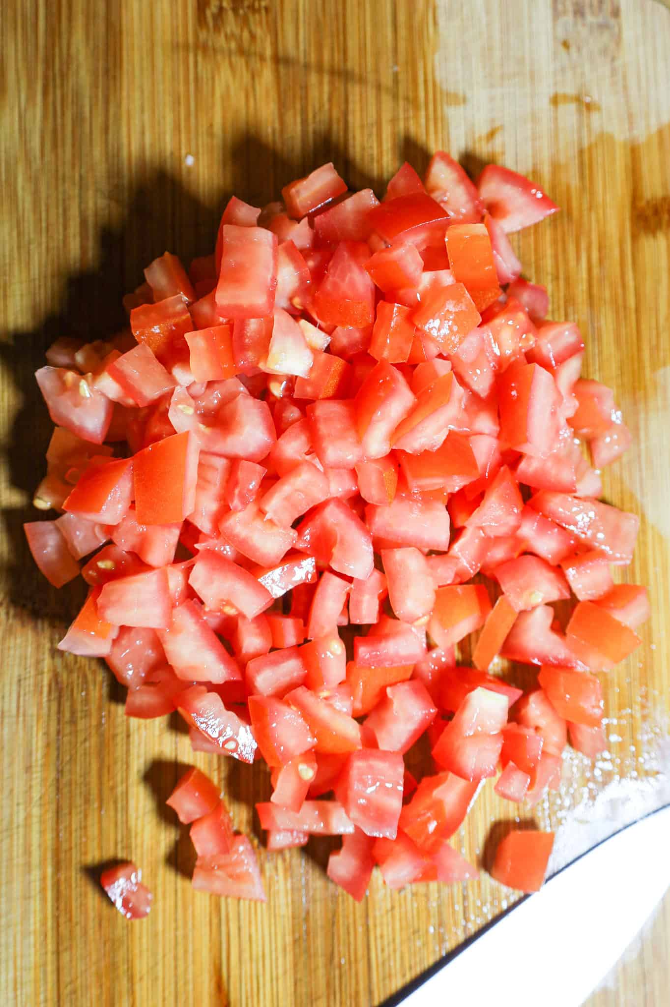 diced tomatoes on a cutting board