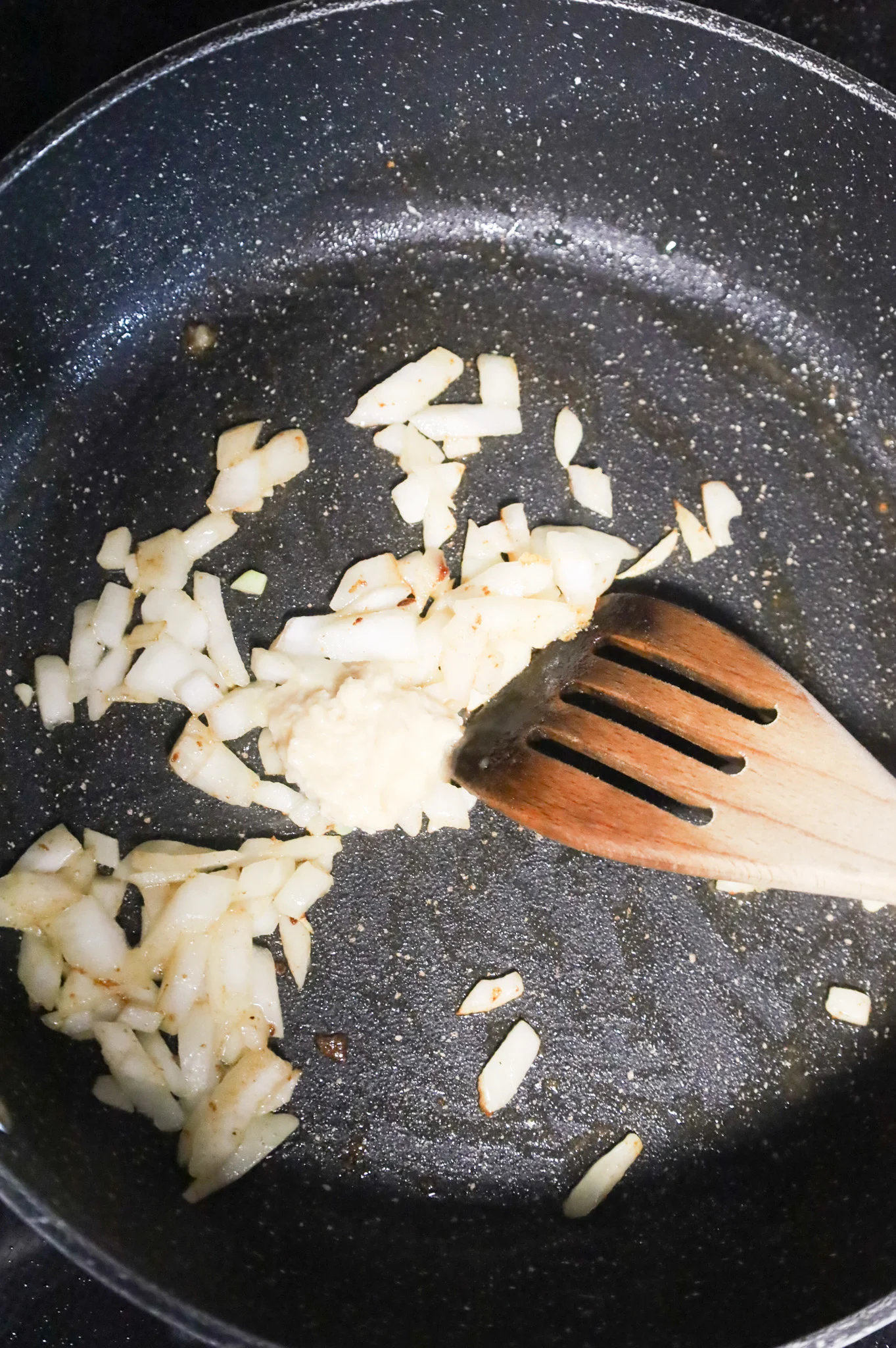 diced onions and garlic puree in a skillet