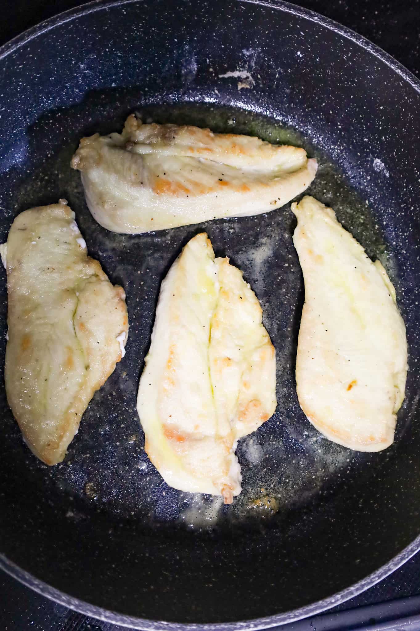 seared chicken cutlets in a skillet