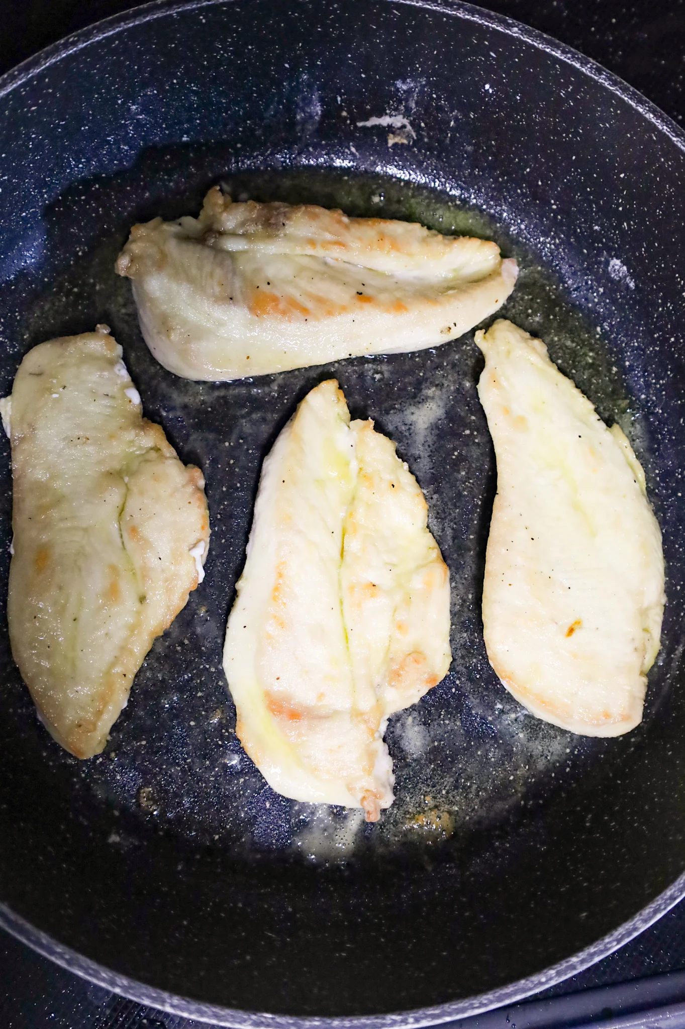 seared chicken cutlets in a skillet