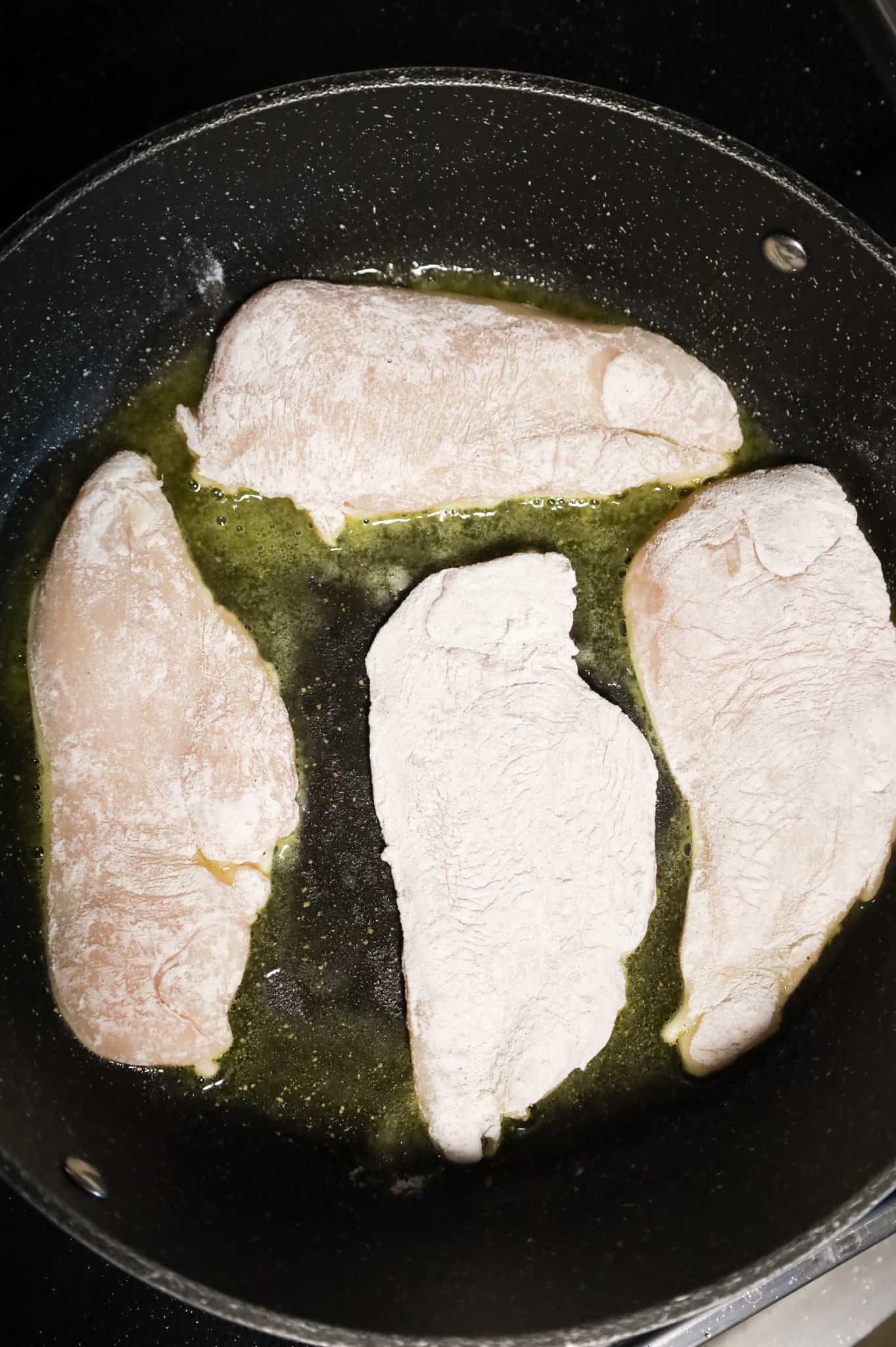 chicken cutlets in hot oil in a skillet