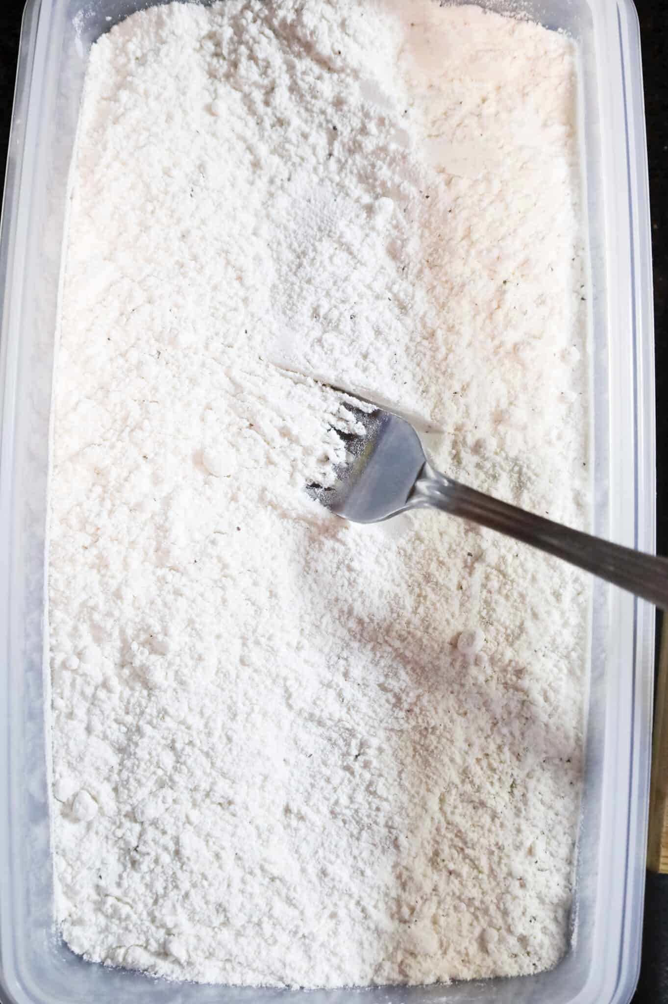 stirring flour in a shallow dish