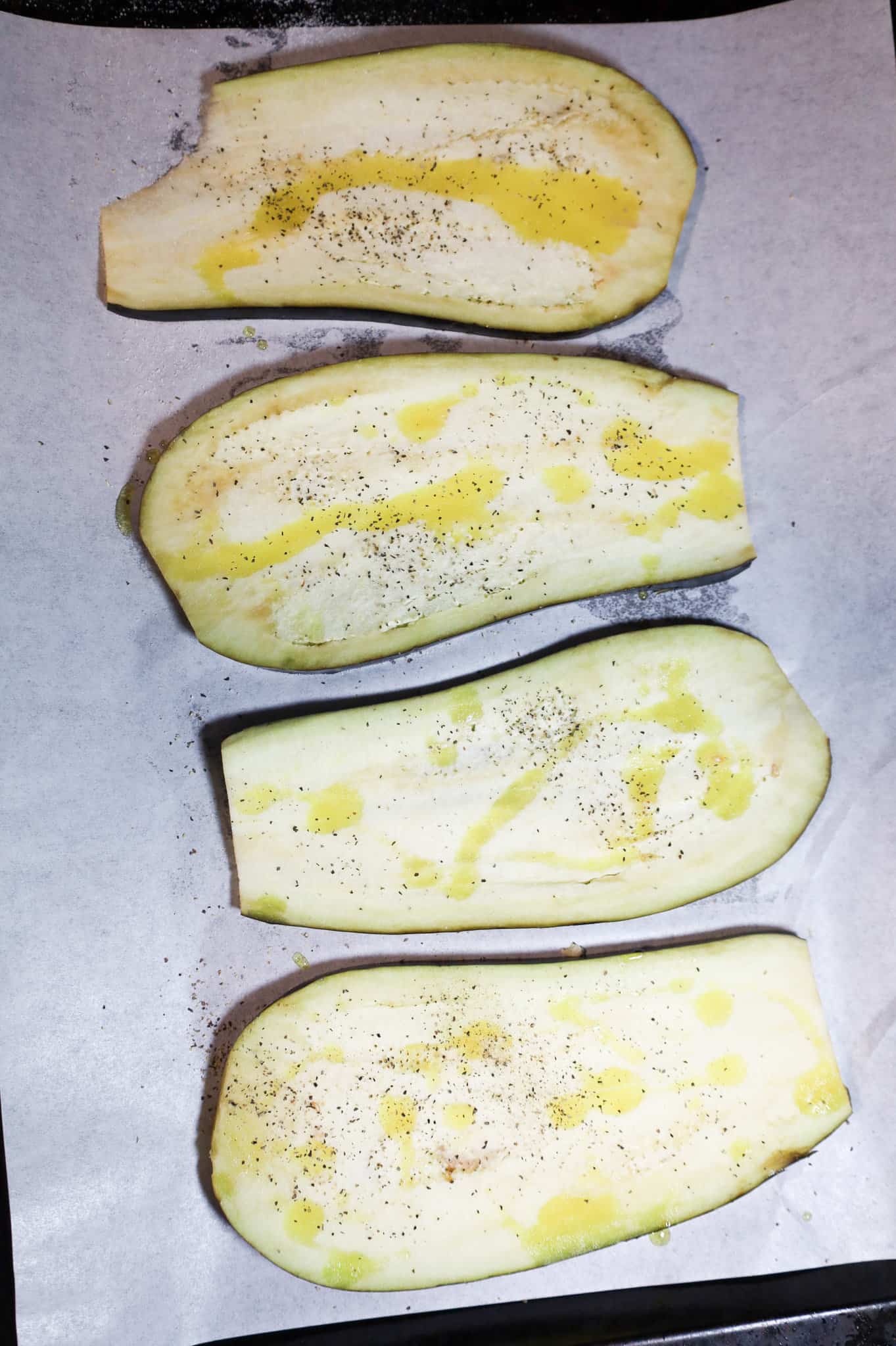 eggplant slices drizzled with olive oil and seasoned with salt and pepper