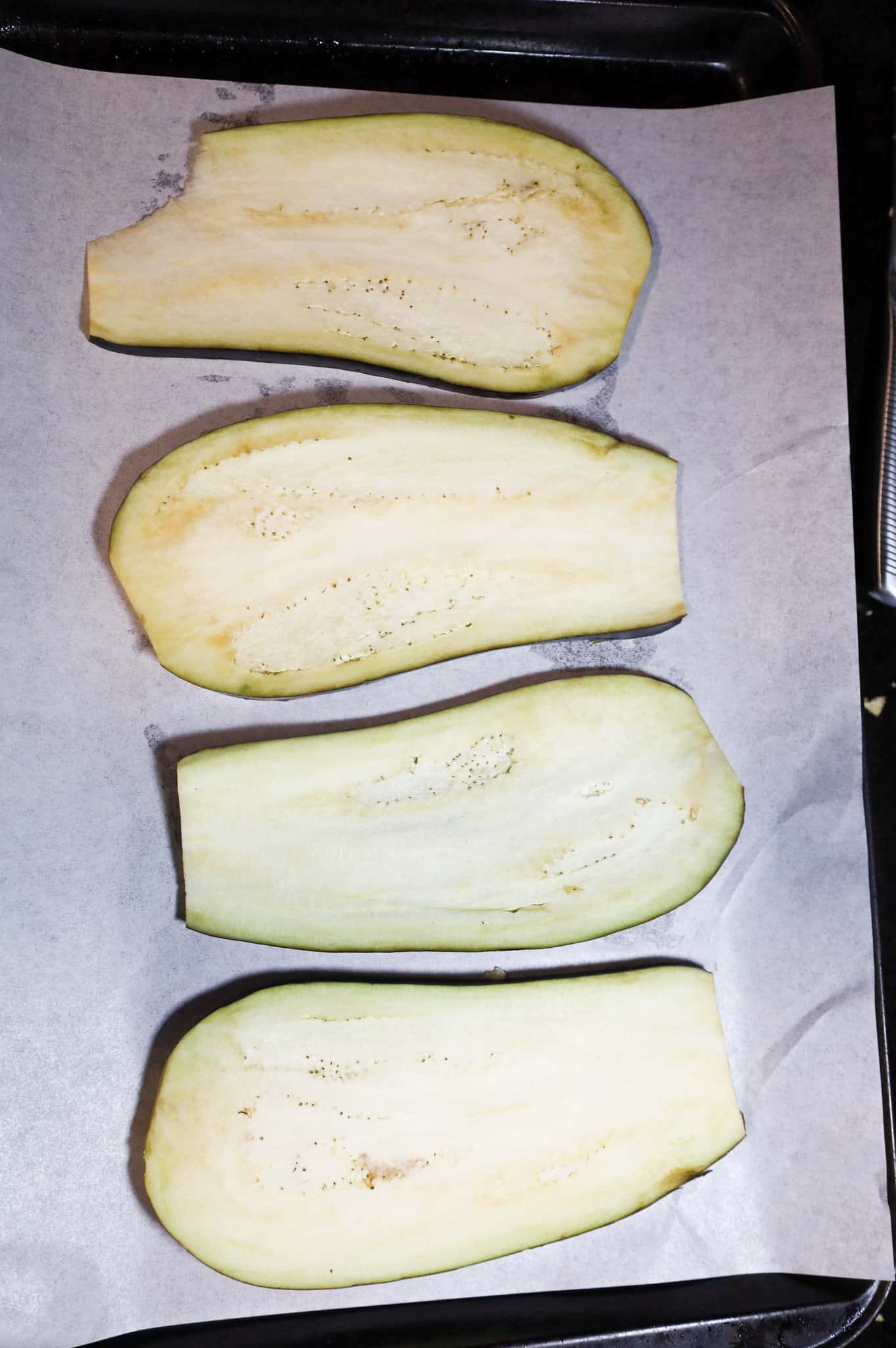 eggplant slices on a parchment lined baking sheet