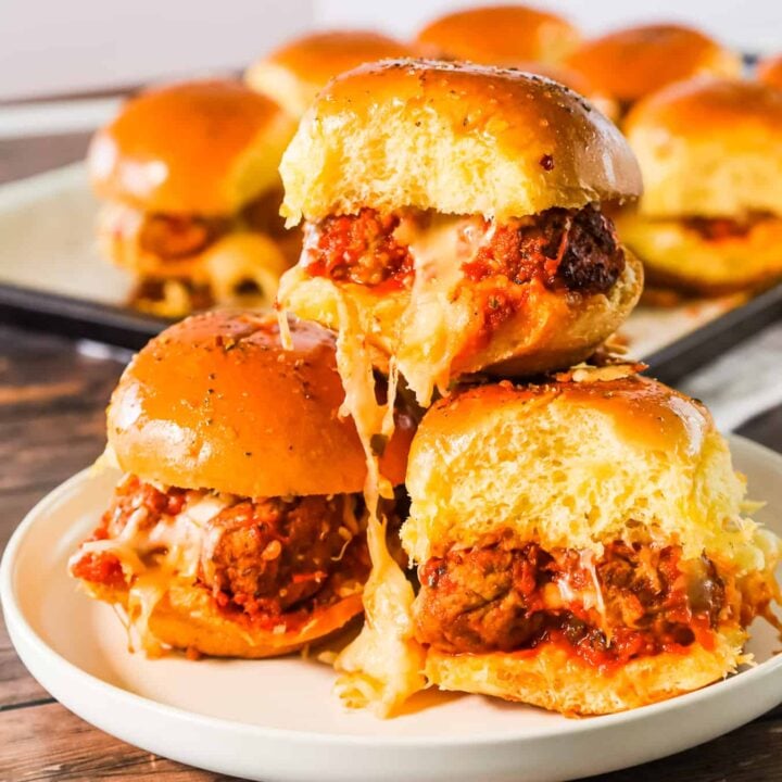 Meatball Sliders are an easy weeknight dinner recipe using frozen meatballs, marinara sauce, shredded mozzarella and parmesan cheese all baked on dinner rolls.