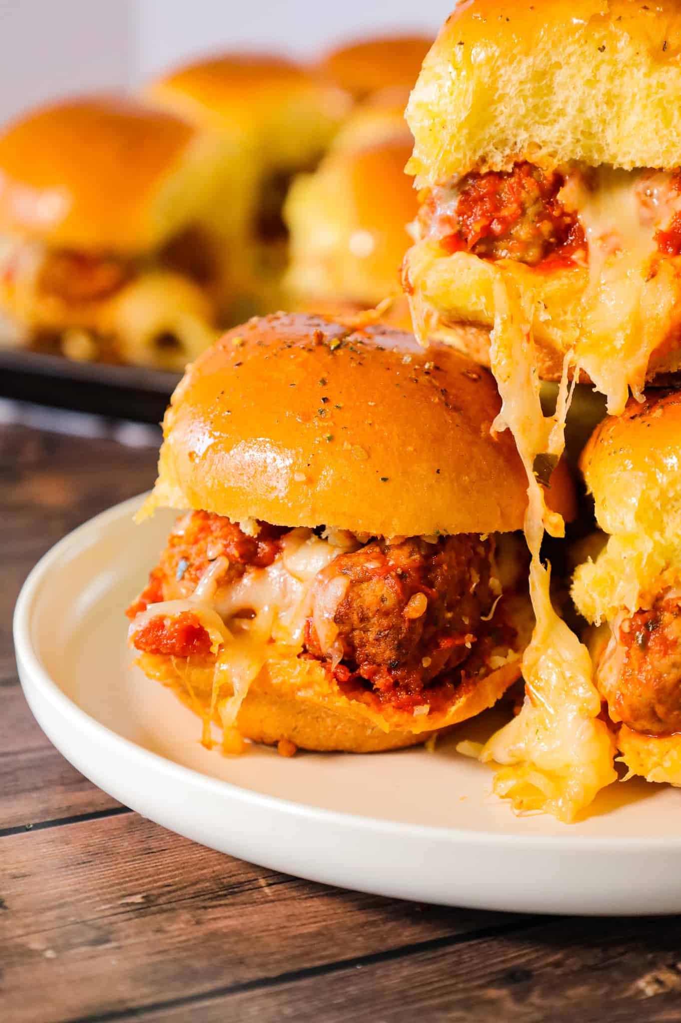 Meatball Sliders are an easy weeknight dinner recipe using frozen meatballs, marinara sauce, shredded mozzarella and parmesan cheese all baked on dinner rolls.