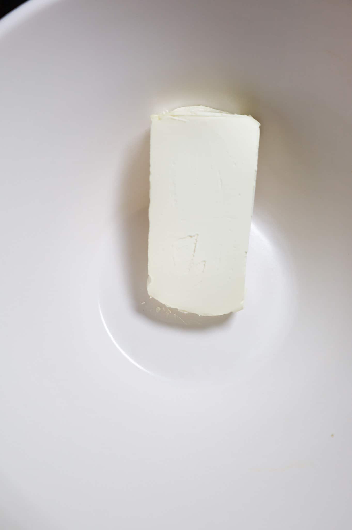 cream cheese brick in a mixing bowl