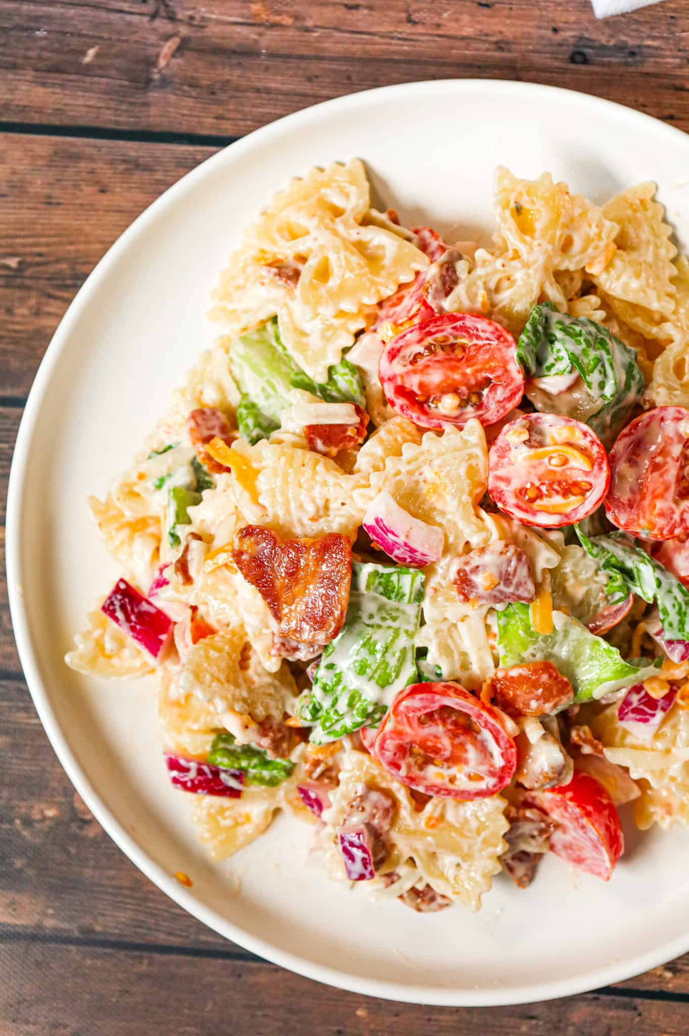 BLT Pasta Salad is a delicious cold side dish recipe made with bowtie pasta and loaded with chopped bacon, grape tomatoes, red onions and shredded cheese.