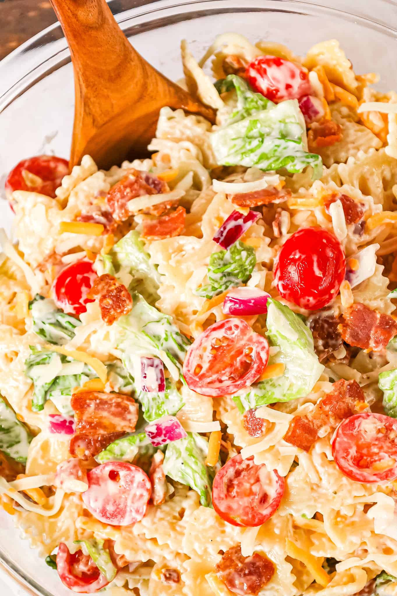 BLT Pasta Salad is a delicious cold side dish recipe made with bowtie pasta and loaded with chopped bacon, grape tomatoes, red onions and shredded cheese.