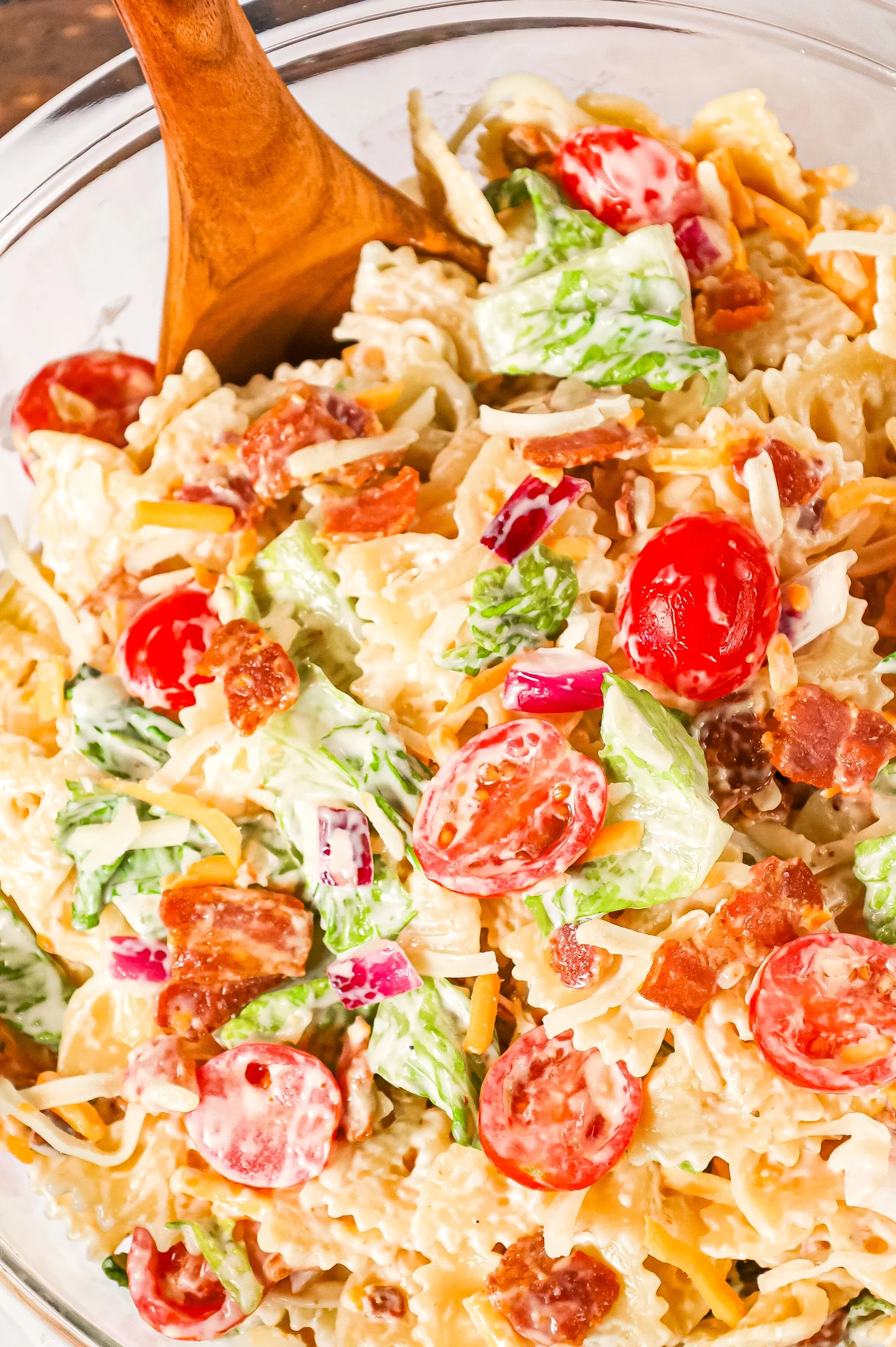 BLT Pasta Salad is a delicious cold side dish recipe made with bowtie pasta and loaded with chopped bacon, grape tomatoes, red onions and shredded cheese.