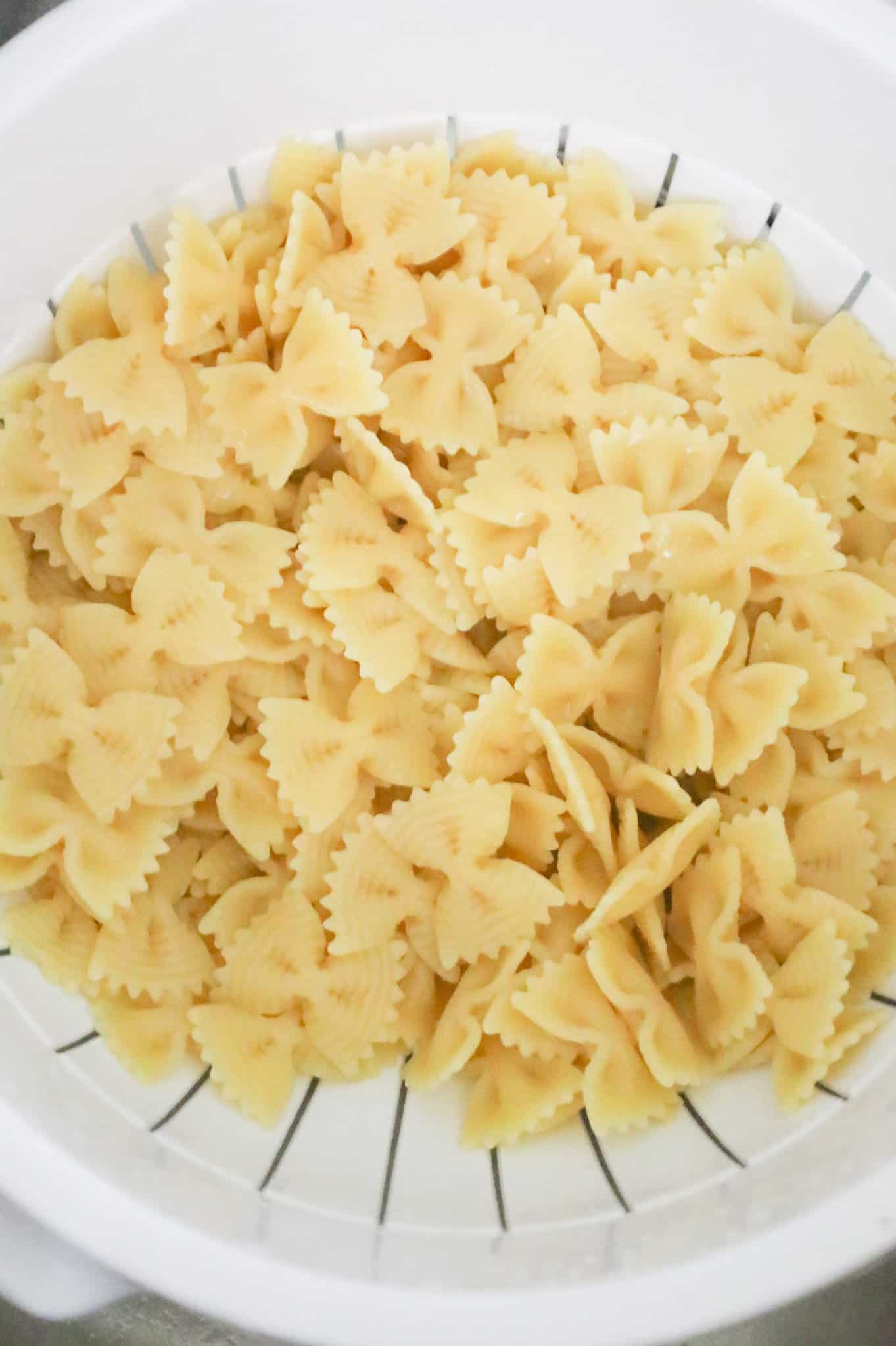 cooked bowtie pasta in a colander