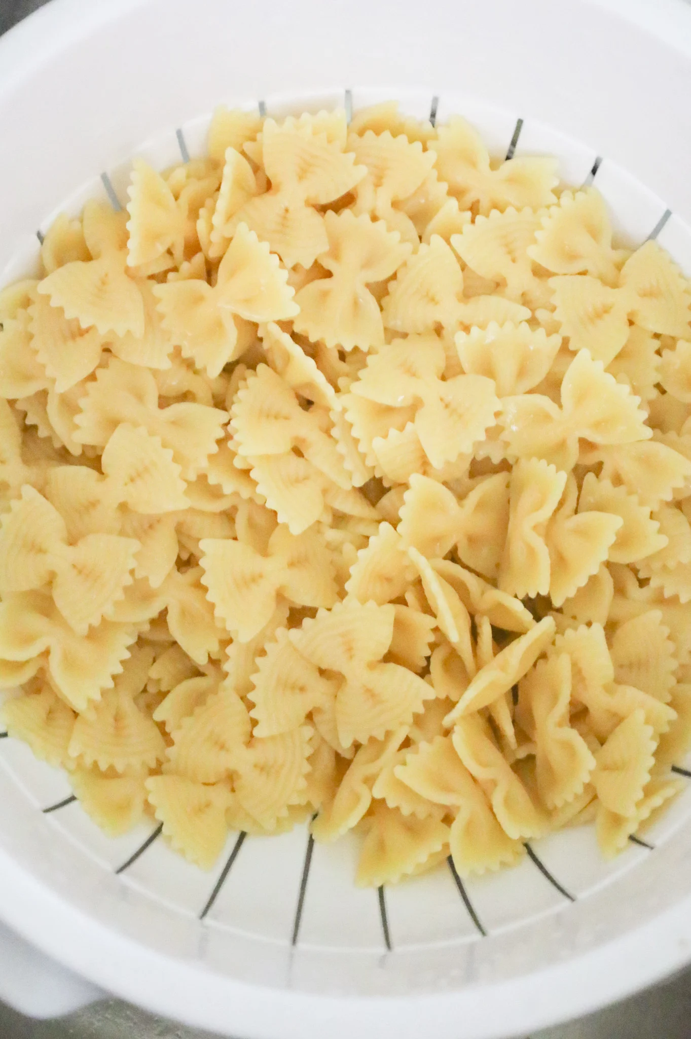 cooked bowtie pasta in a colander