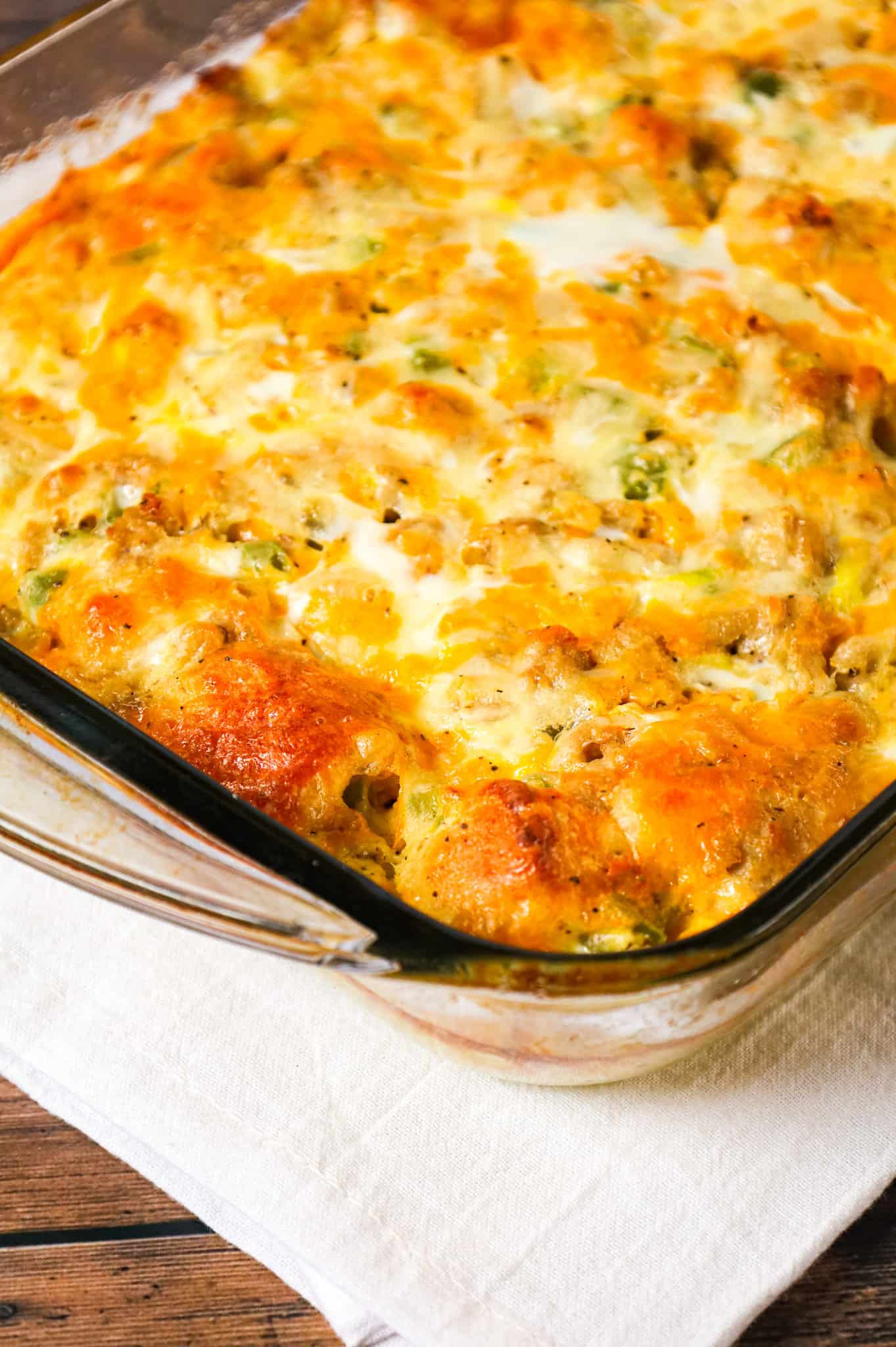 Breakfast Casserole with Biscuits is an easy breakfast dish loaded with sausage, egg, green peppers, Pillsbury biscuits and shredded cheese.