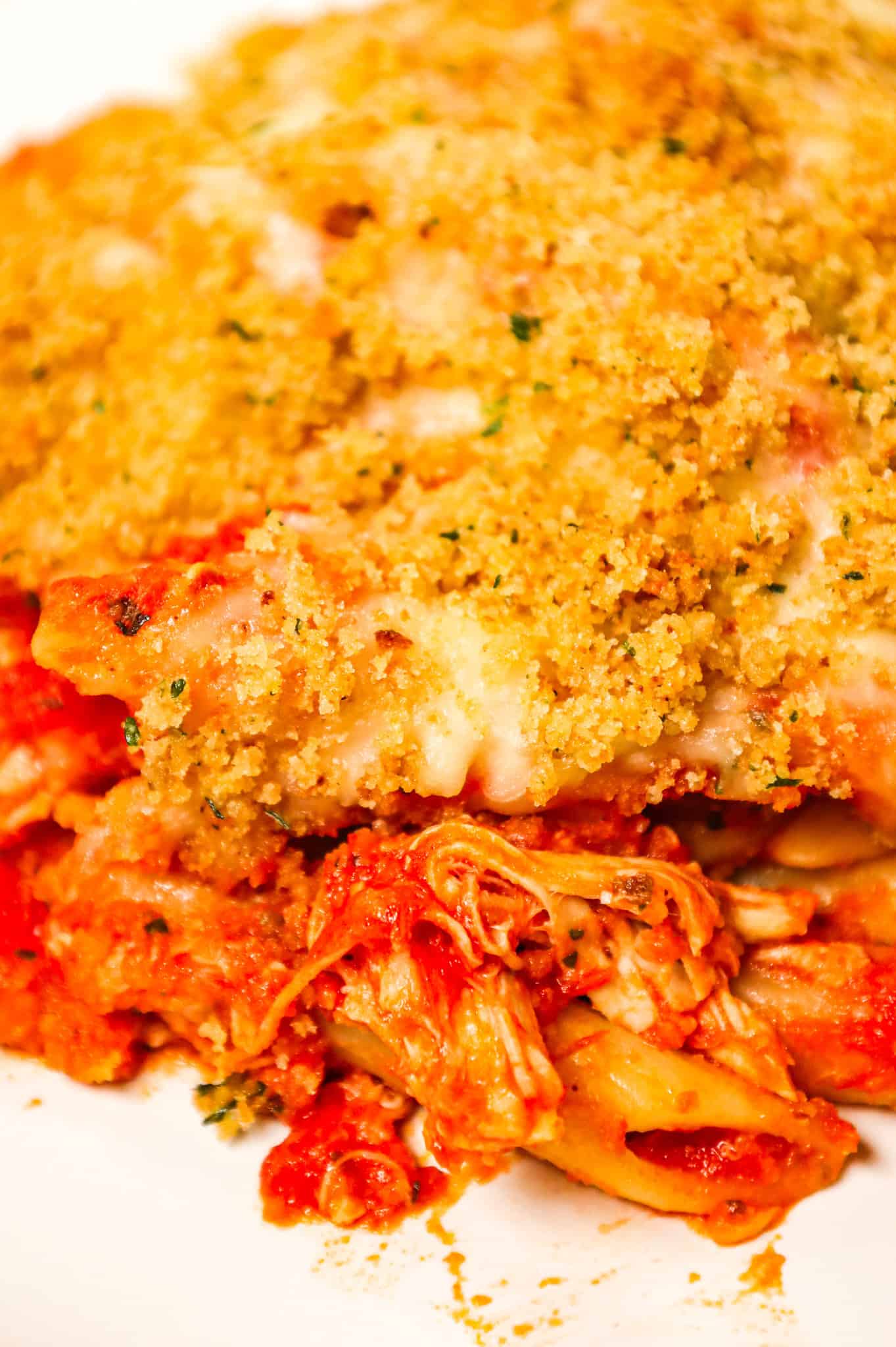 Chicken Parmesan Pasta is an easy baked pasta recipe loaded with shredded chicken, marinara sauce, mozzarella, parmesan cheese and topped with Italian seasoned bread crumbs.