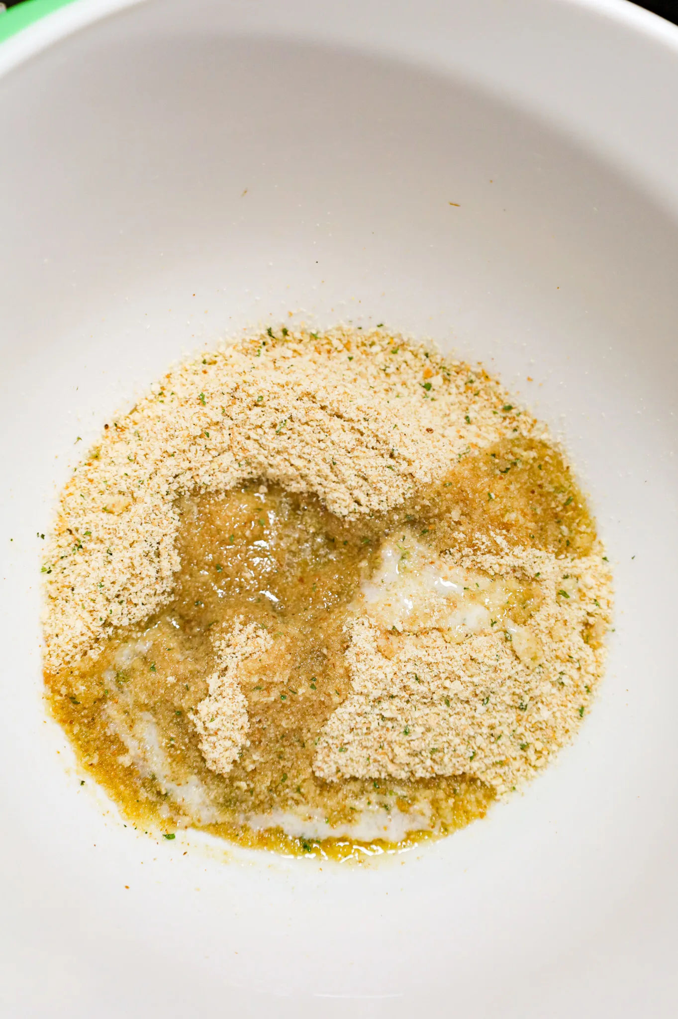 melted butter and Italian seasoned bread crumbs in a mixing bowl