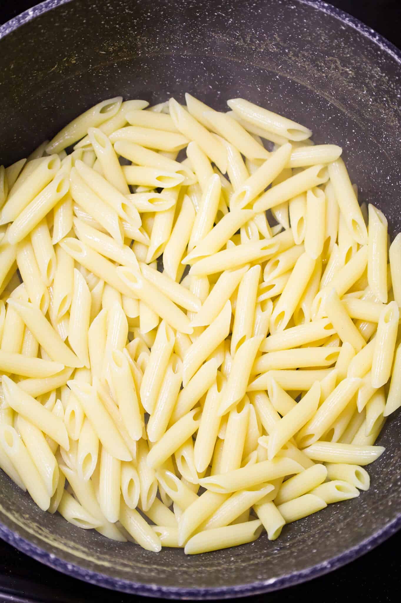 cooked penne pasta in a large pot