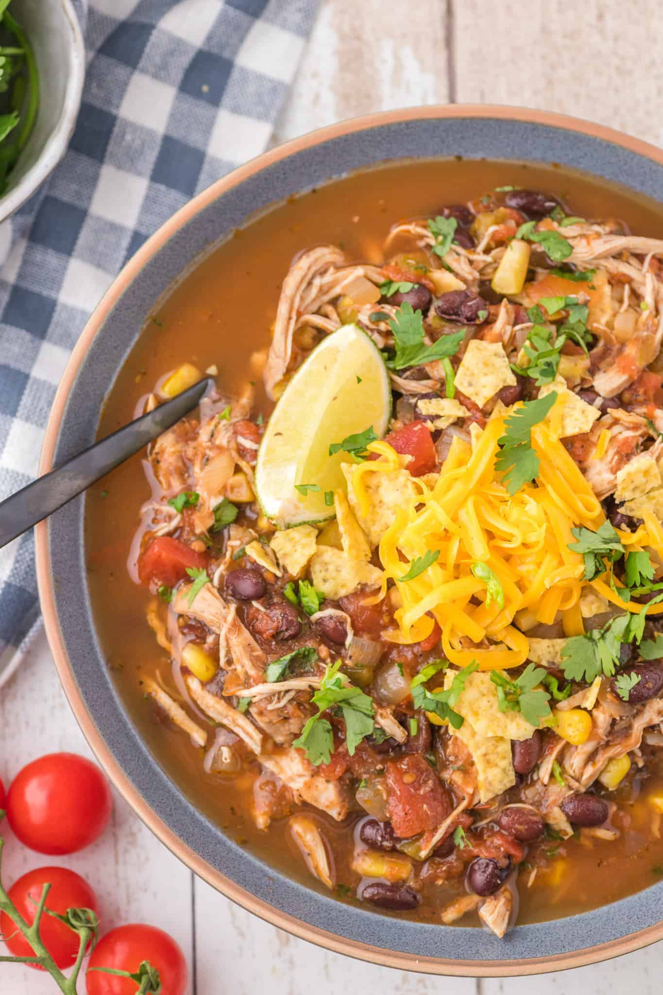 Chicken Taco Soup is a hearty soup recipe loaded with shredded chicken, black beans, corn, tomatoes and spices.