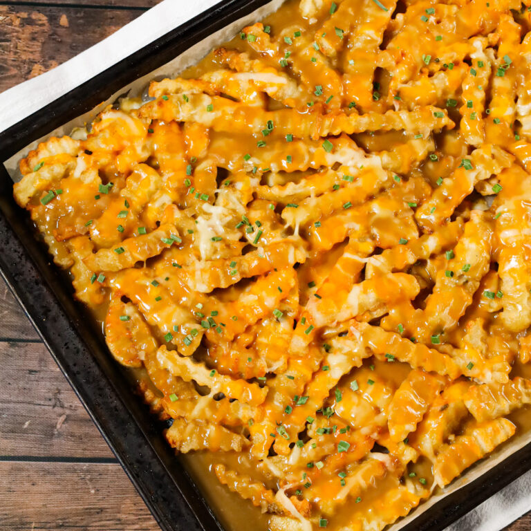 Disco Fries are an easy side dish recipe made with French fries and loaded with melted cheese and gravy.