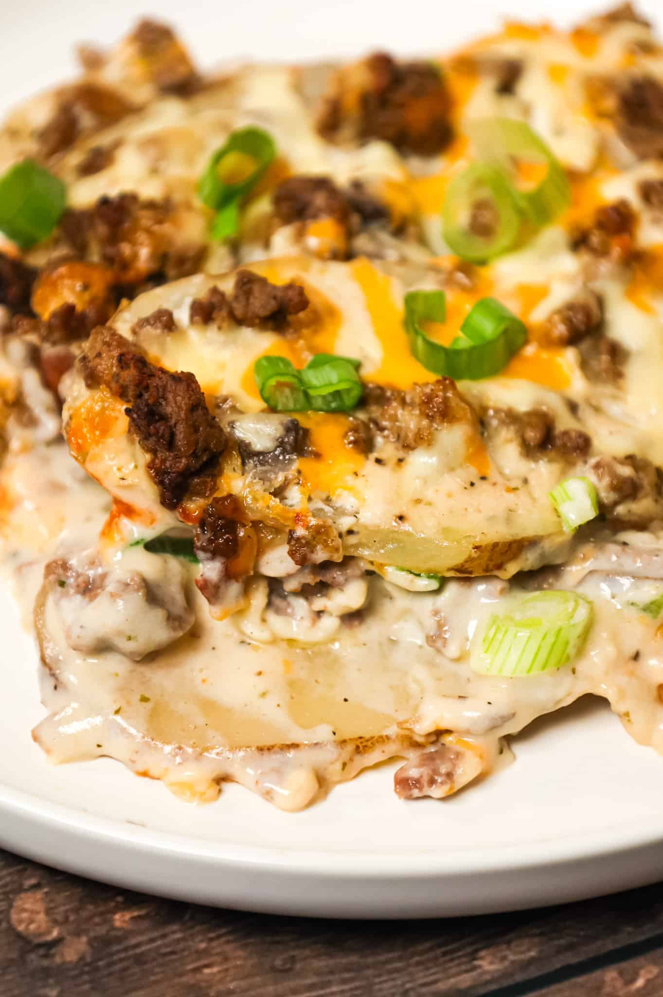 Hamburger Potato Casserole is a hearty dinner recipe with layers of sliced potatoes loaded with crumbled ground beef and shredded cheese all cooked in a cream of mushroom soup and sour cream mixture.