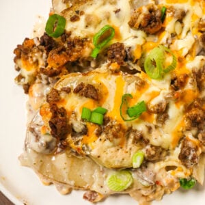 Hamburger Potato Casserole is a hearty dinner recipe with layers of sliced potatoes loaded with crumbled ground beef and shredded cheese all cooked in a cream of mushroom soup and sour cream mixture.