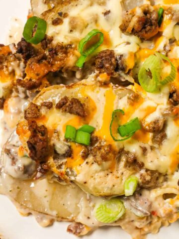 Hamburger Potato Casserole is a hearty dinner recipe with layers of sliced potatoes loaded with crumbled ground beef and shredded cheese all cooked in a cream of mushroom soup and sour cream mixture.