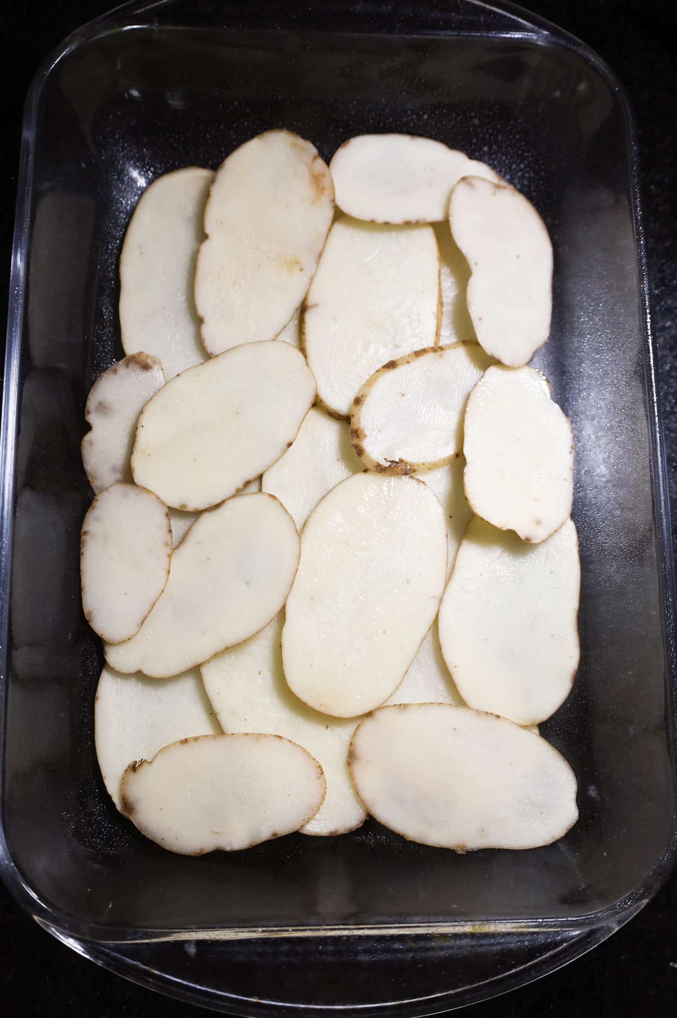 sliced potatoes in a baking dish