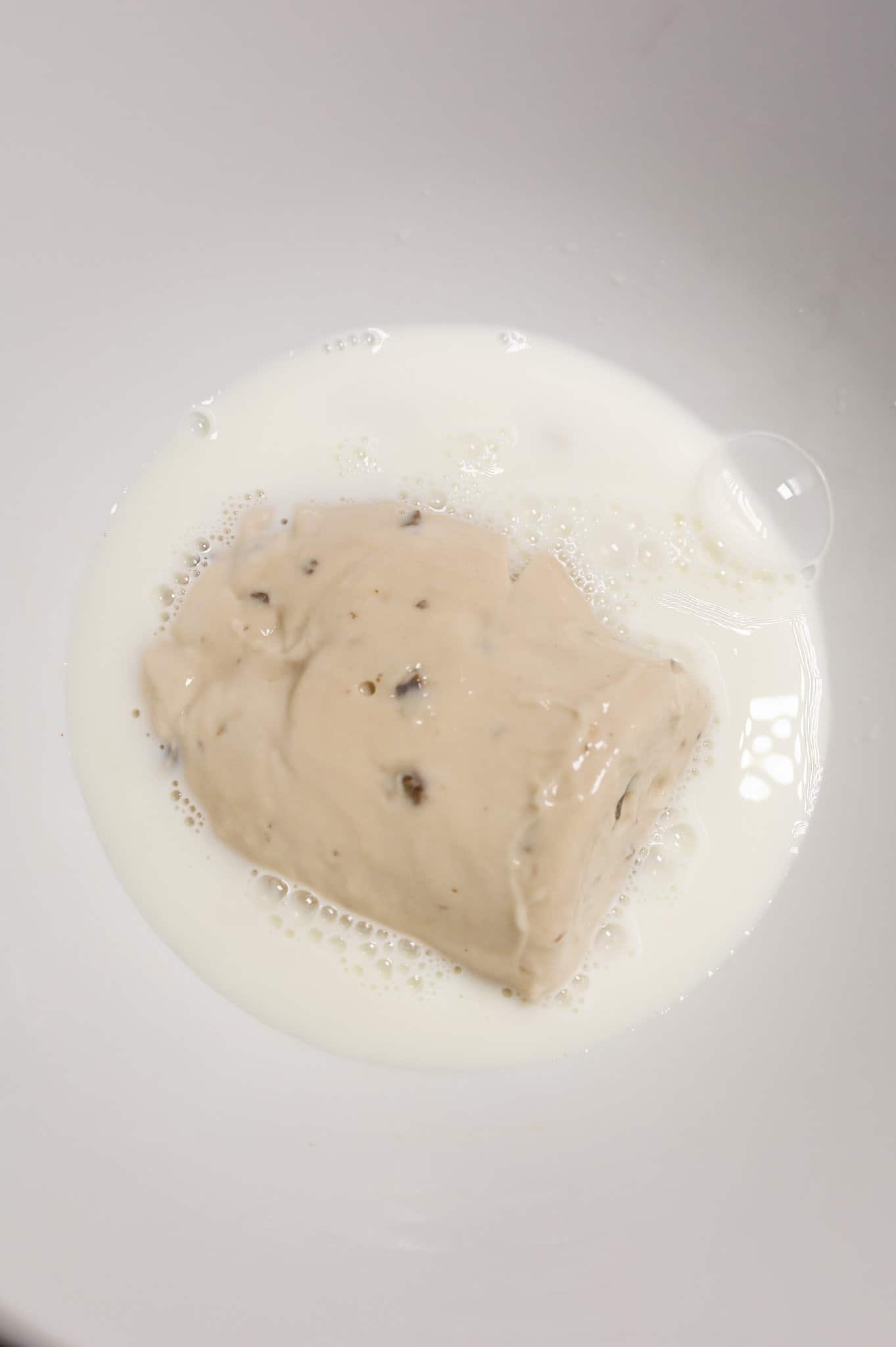 cream of mushroom soup and milk in a mixing bowl