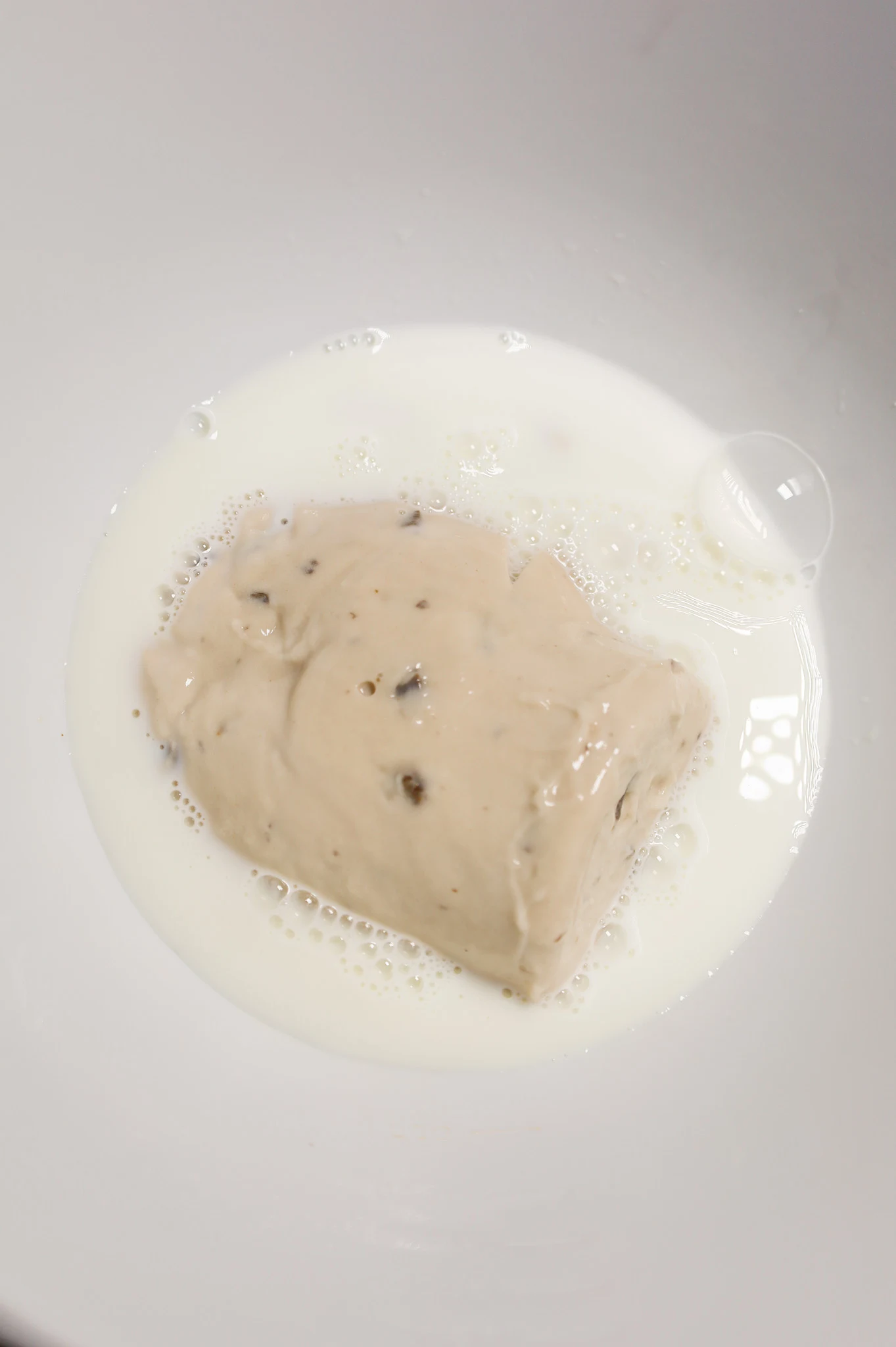 cream of mushroom soup and milk in a mixing bowl