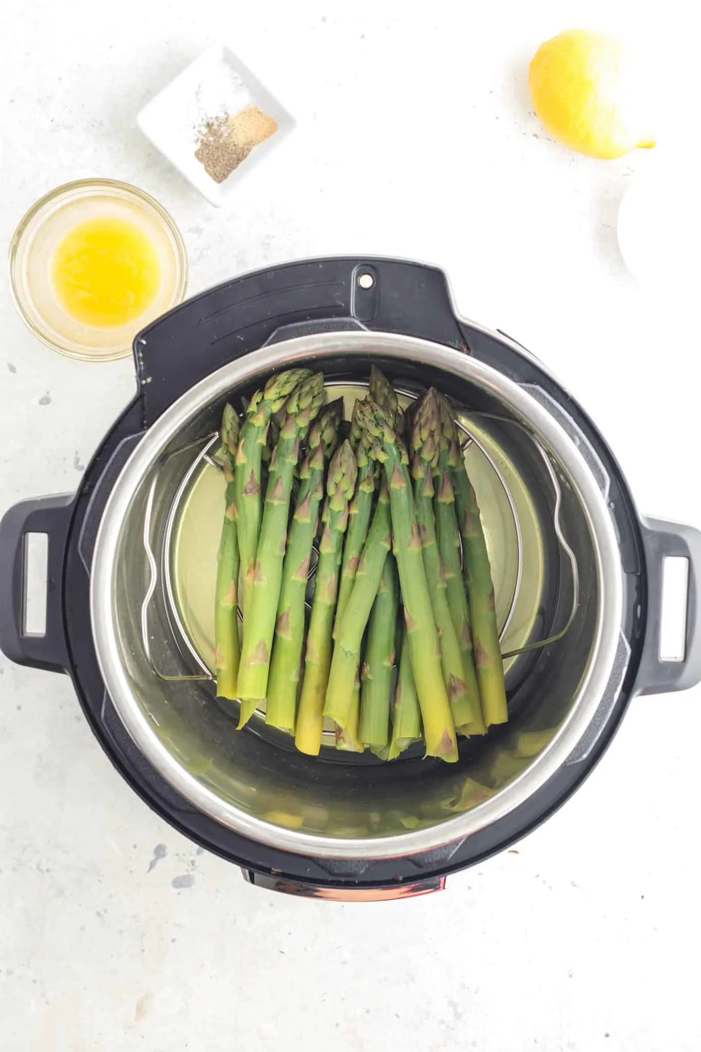 asparagus on a trivet in an instant pot after cooking
