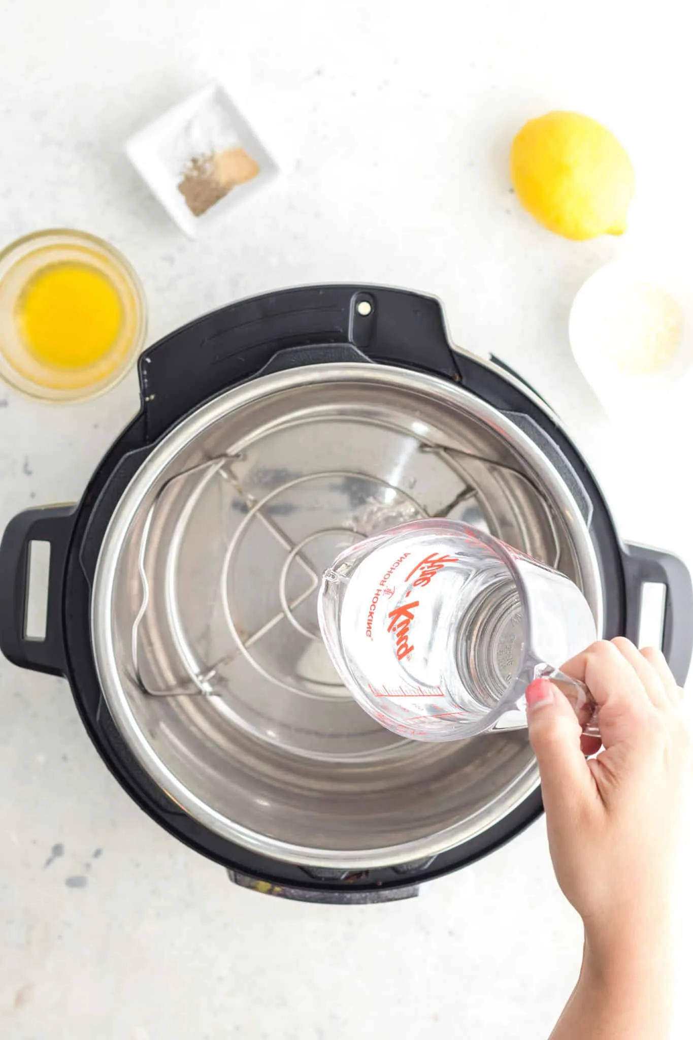 pouring water into an Instant Pot with a trivet