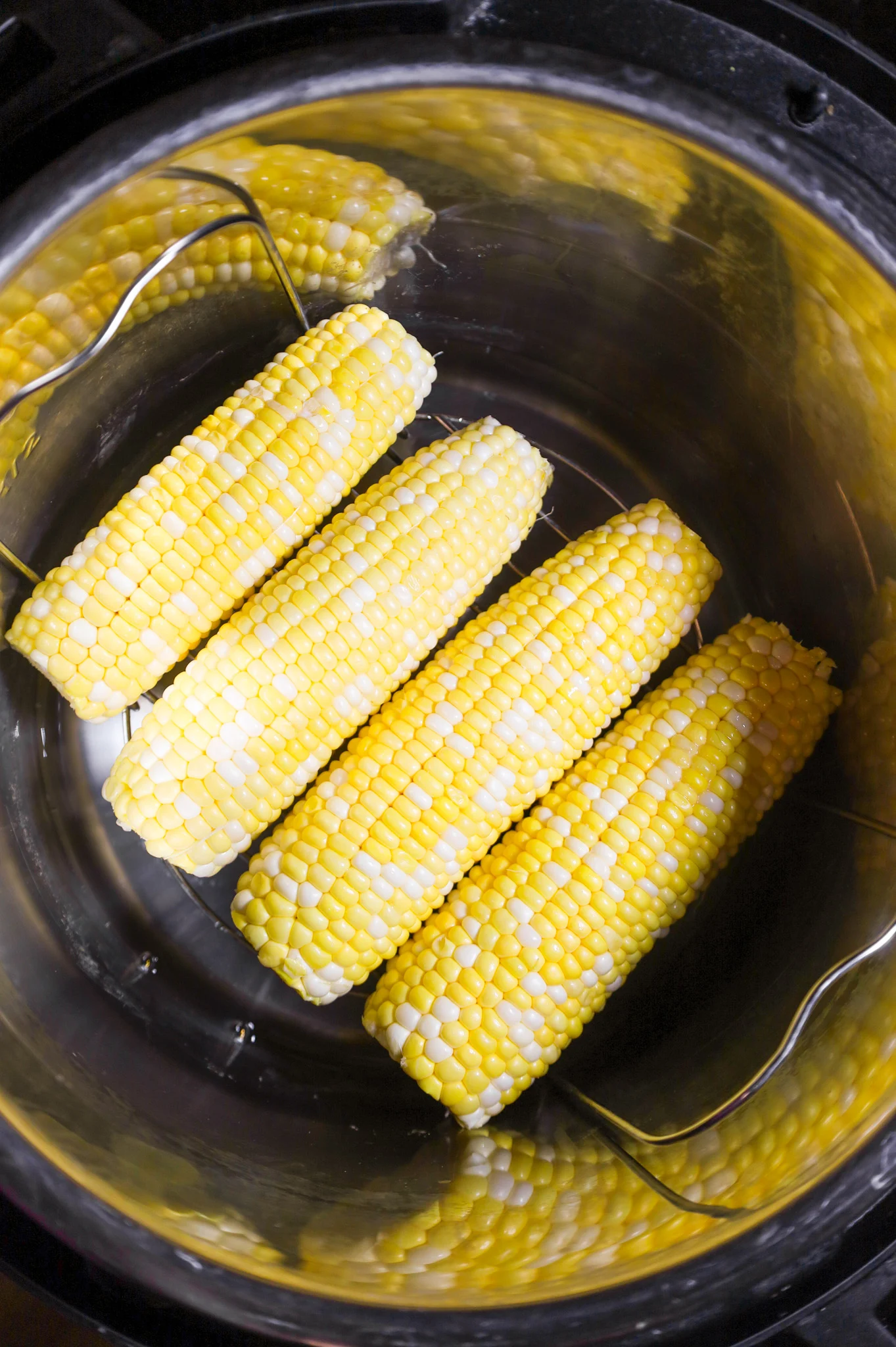 corn on the cob on a trivet in an Instant Pot