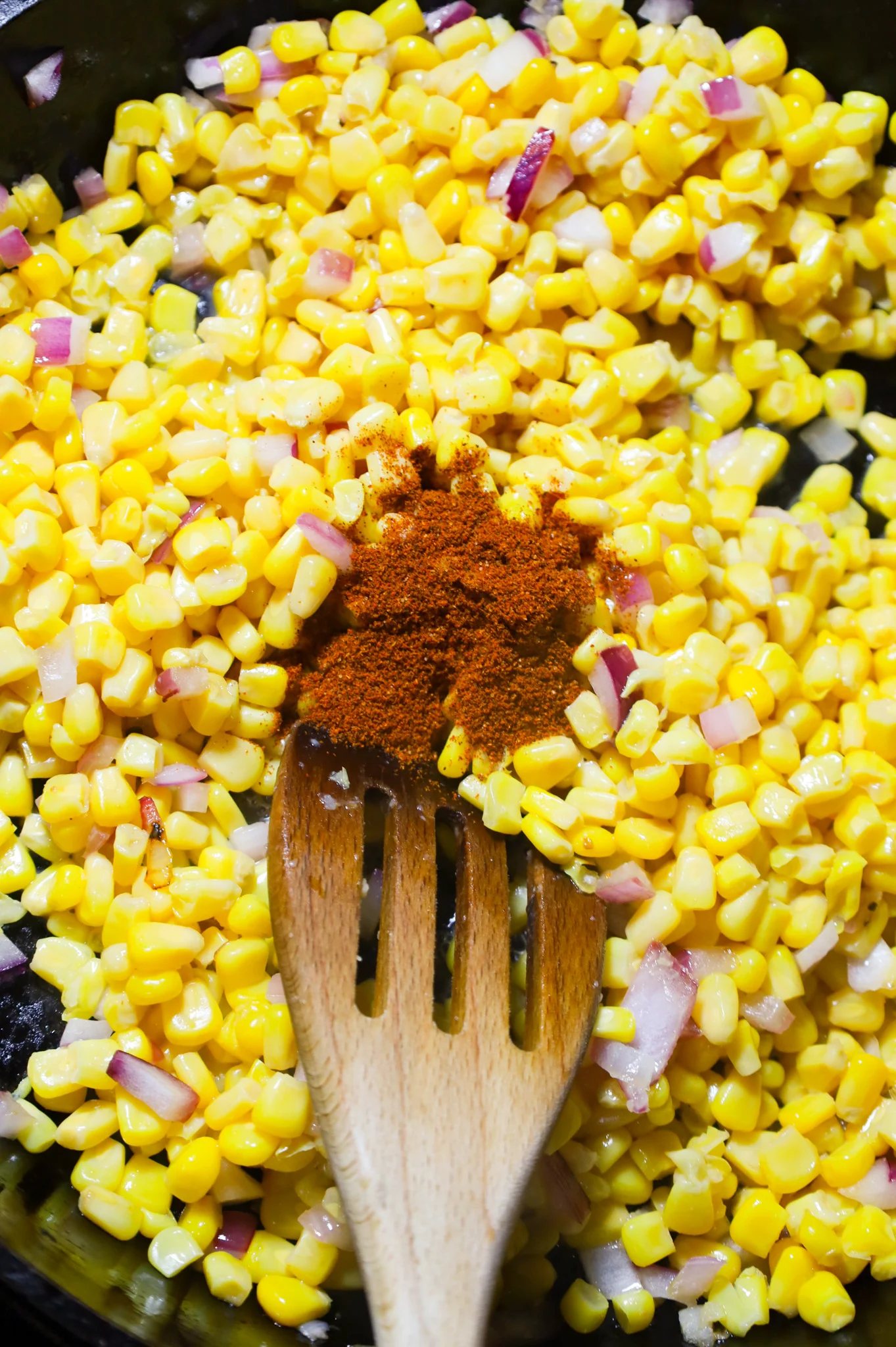 chili powder on top of corn in a skillet