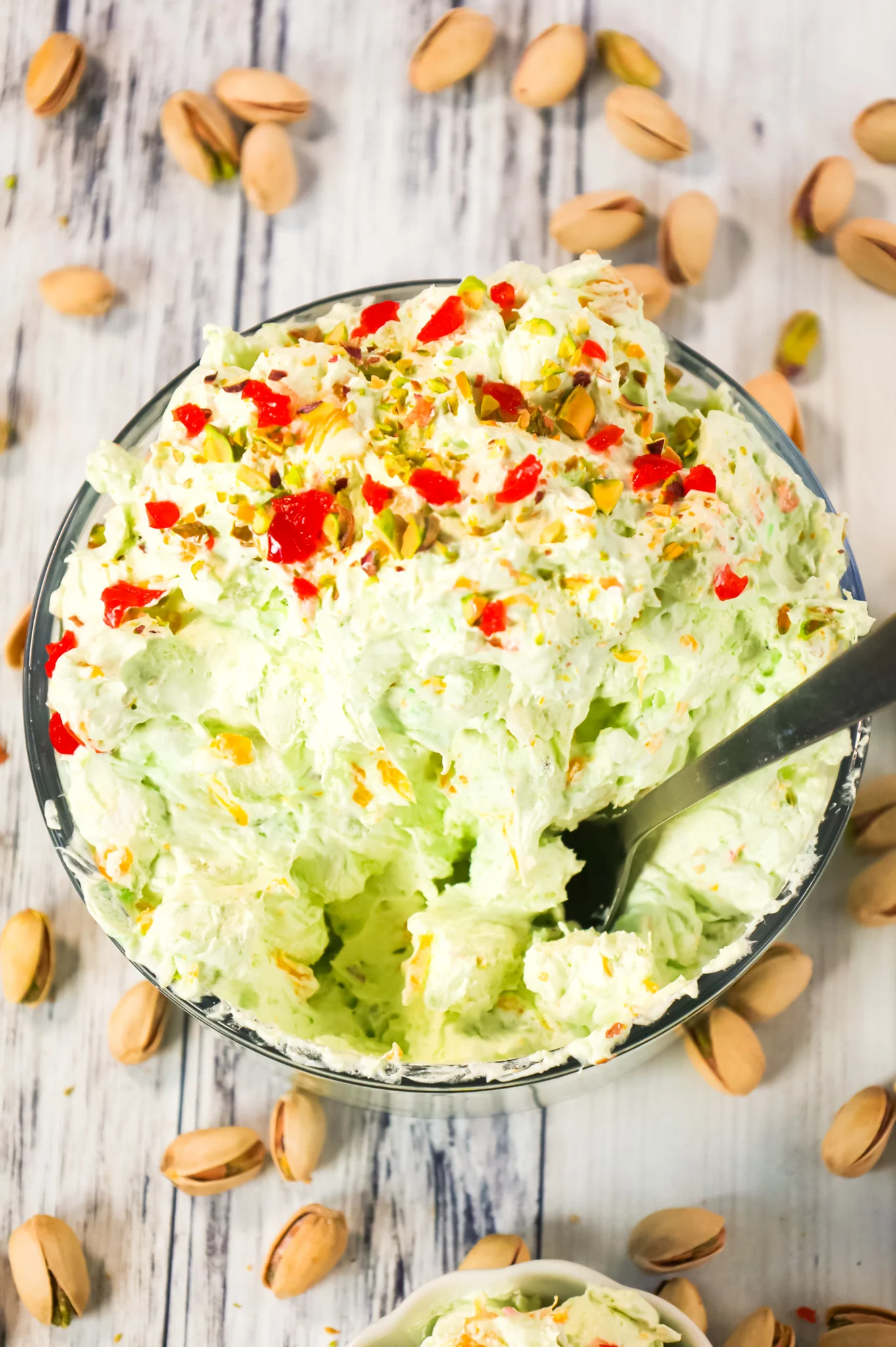 Pistachio Fluff Salad is a delicious side dish or dessert recipe loaded with crushed pineapple, mandarin segments, pistachio pudding mix, mini marshmallows and Cool Whip.
