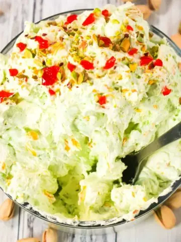 Pistachio Fluff Salad is a delicious side dish or dessert recipe loaded with crushed pineapple, mandarin segments, pistachio pudding mix, mini marshmallows and Cool Whip.