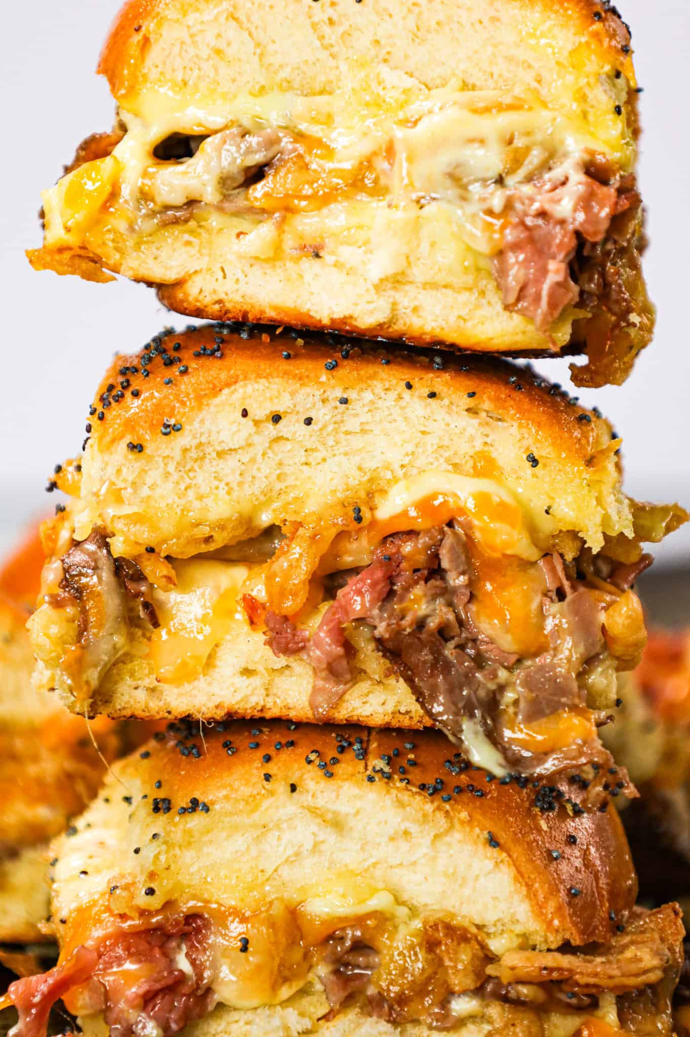 Roast Beef Sliders are an easy dinner or party snack made with dinner rolls and loaded with deli shaved roast beef, mayo, horseradish, mozzarella, cheddar and crispy fried onions.